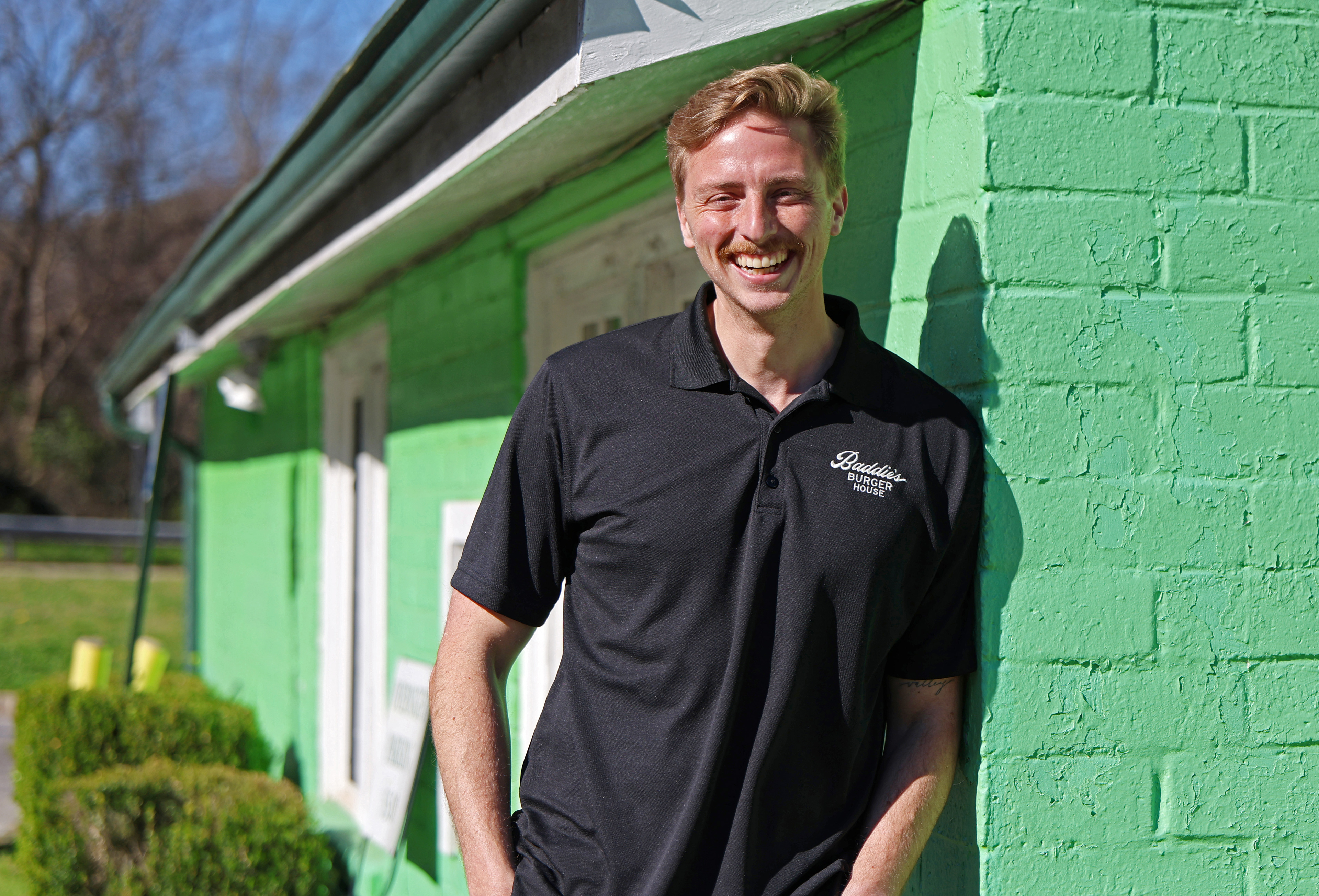 Joe Nedza poses for a portrait outside of the former location of Weaver D’s Delicious Fine Foods in Athens, Georgia, on Tuesday, March 17, 2026. Nedza, founder and owner of Baddie's Burgers, bought the building in February and plans to open a different restaurant there.