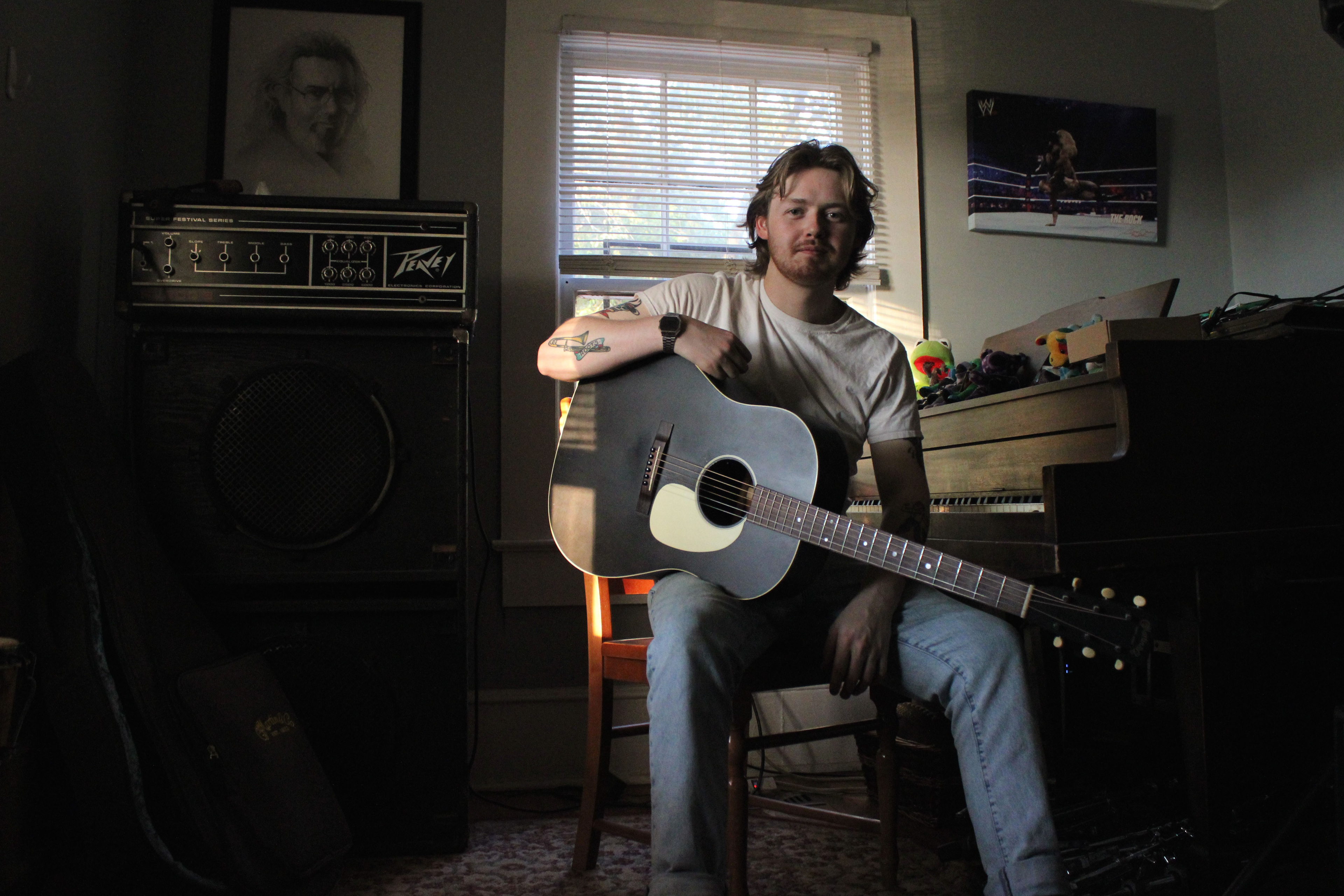 Wim Tapley, 22 of South Riding, Virginia, poses for a portrait in his home music studio off of Macon Highway in Athens, Georgia on Sunday, Oct. 6, 2024. Tapley plays guitar in the band Wim Tapley & The Cannons, which formed in Athens and played their very first concert at Flicker Bar & Theater in December of 2021.