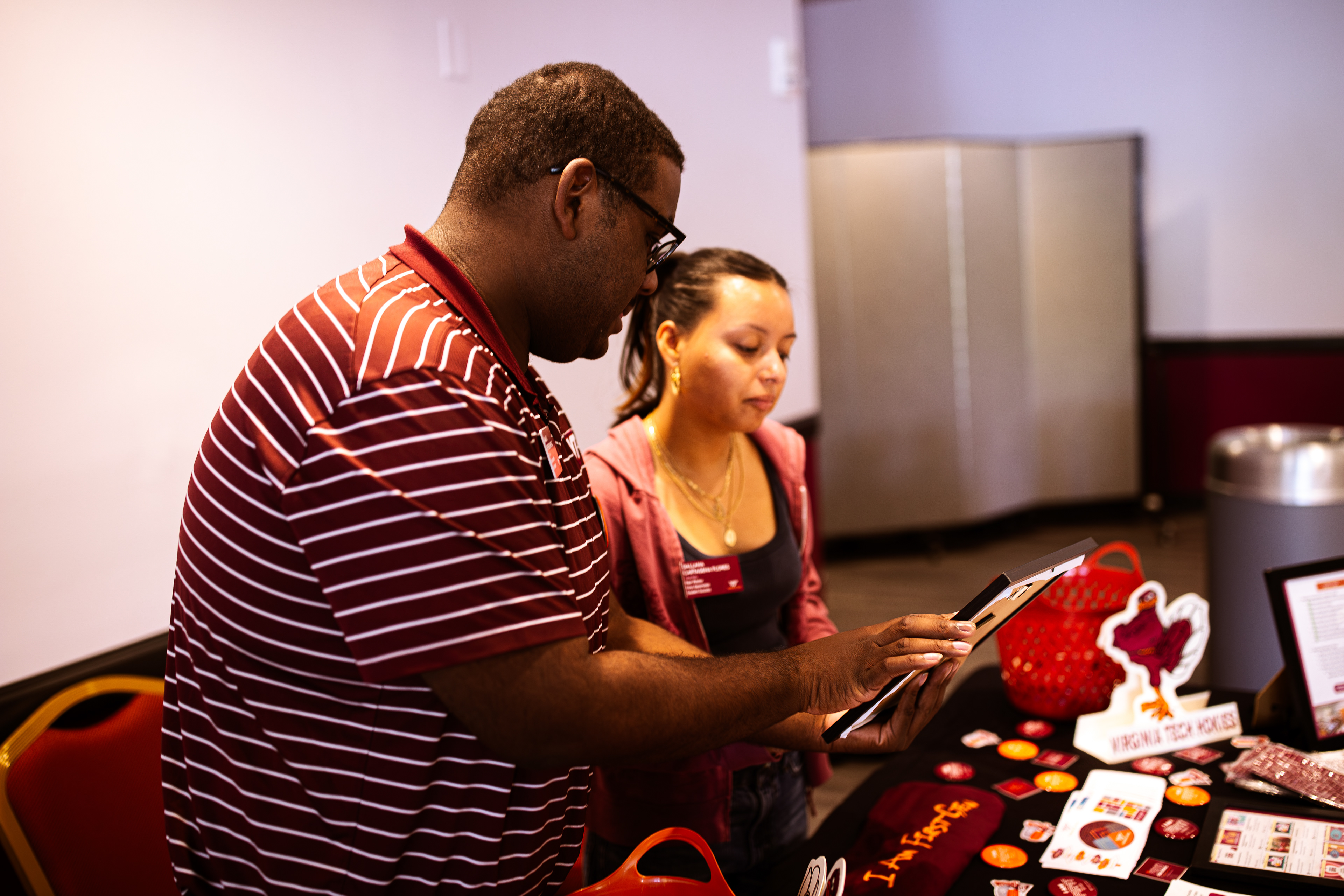 GenerationOne program mentor Jamal Jefferson-Ross shows another member how to present the table to students on Monday, Oct. 14, 2024. (Thomas Bray/JMC 4114)