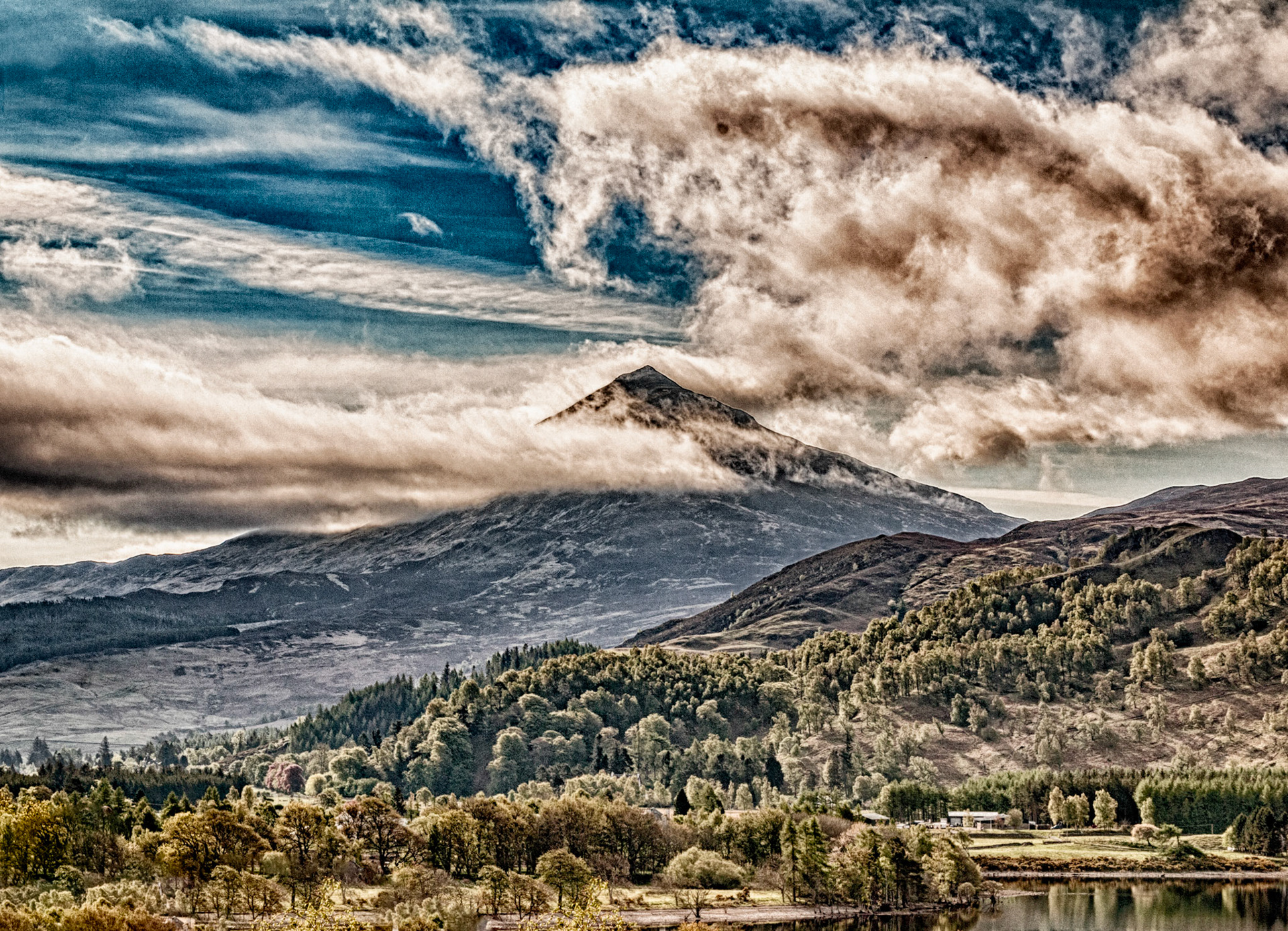 Clouds swirl around the summit of Schiehallion, one of the first mountains you come across whilst heading north towards the Cairngorms in the highlands of Scotland.