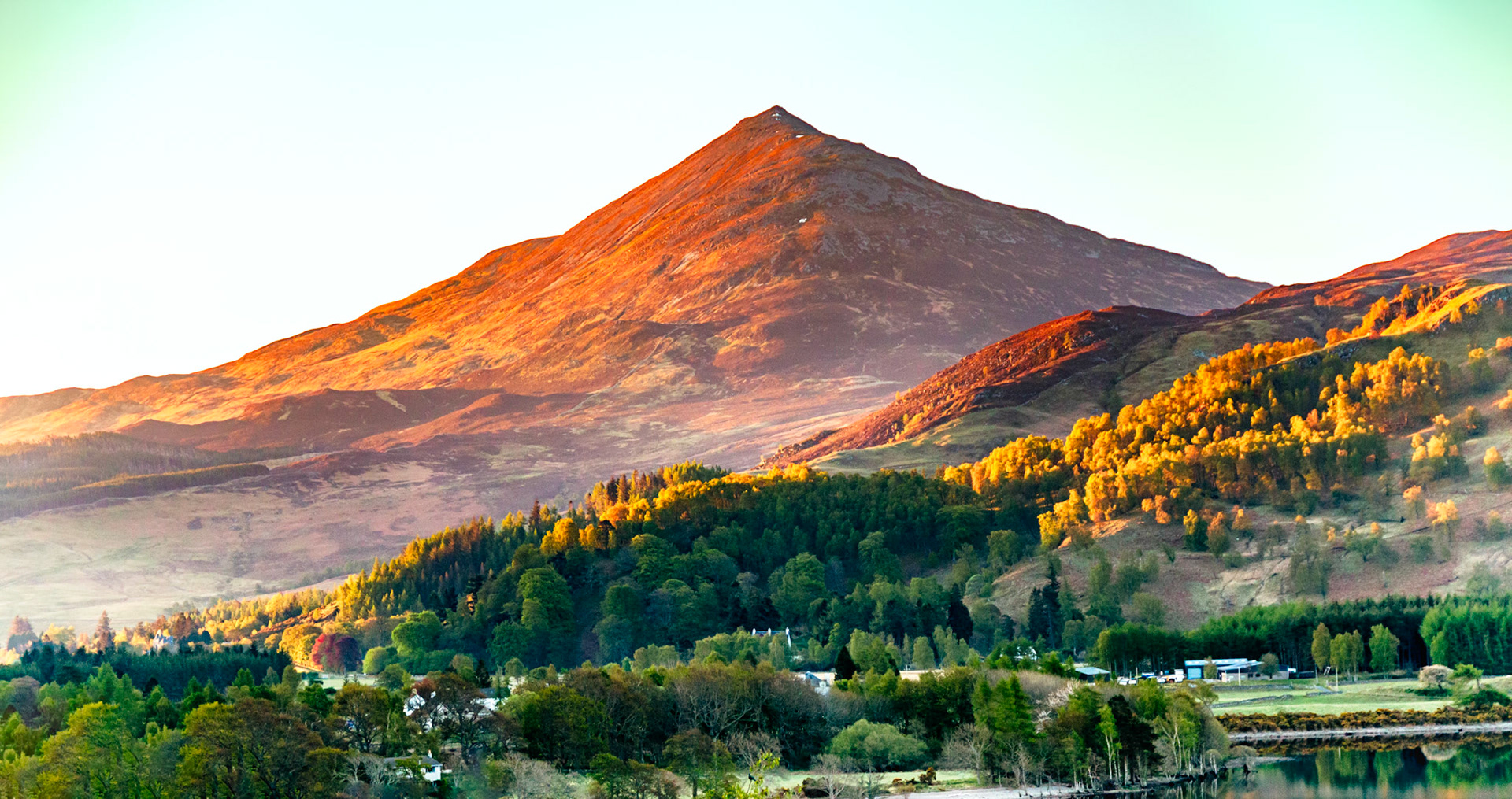 Early morning sunlight creeps across Schiehallion in Perthshire, Scotland. This beauriful mountain is a beacon in the Loch Rannoch area with its stereotypical shape and uncluttered background.