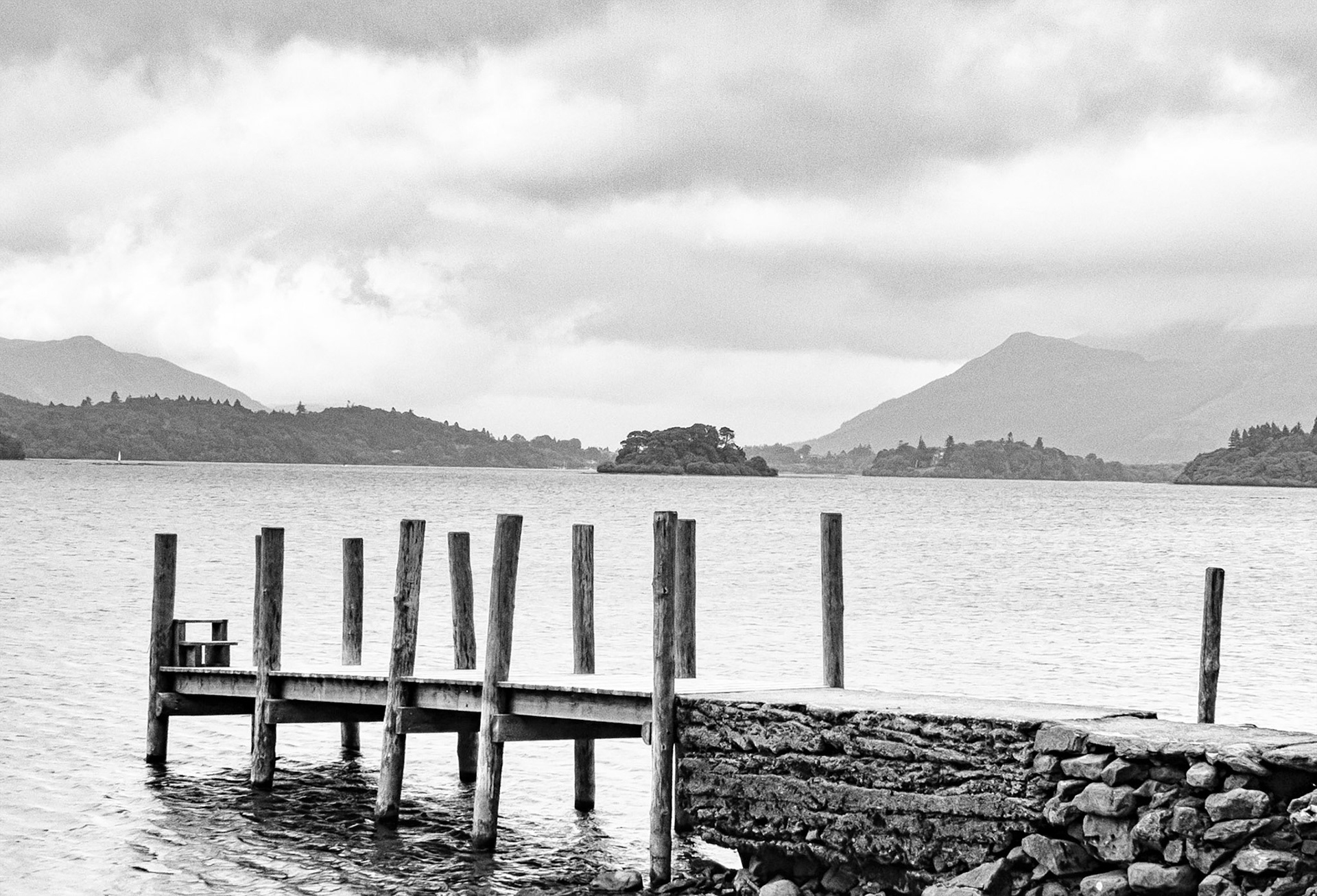 A black and white image portraying a grey overcast day on Derwentwater in the English Lake District