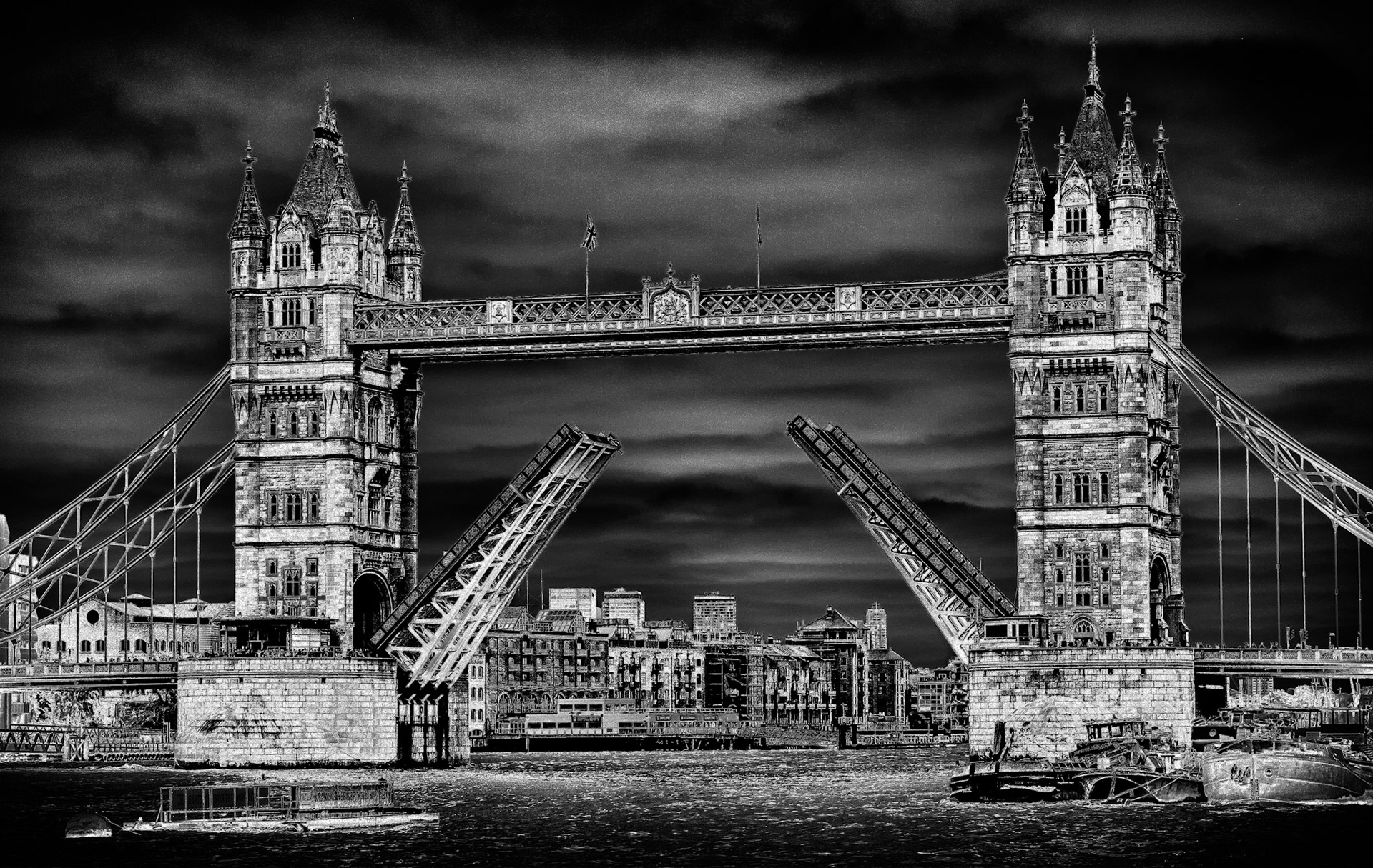A toned image of London's iconic 19th century-built Tower Bridge. The outer brick cladding was changed to harmonise with the nearby Tower of London by George D Stevenson who took over the project after the death of architect Sir Horace Jones. Construction began in 1886 and it was opened by the Prince of Wales, later King Edward VII, in 1894.