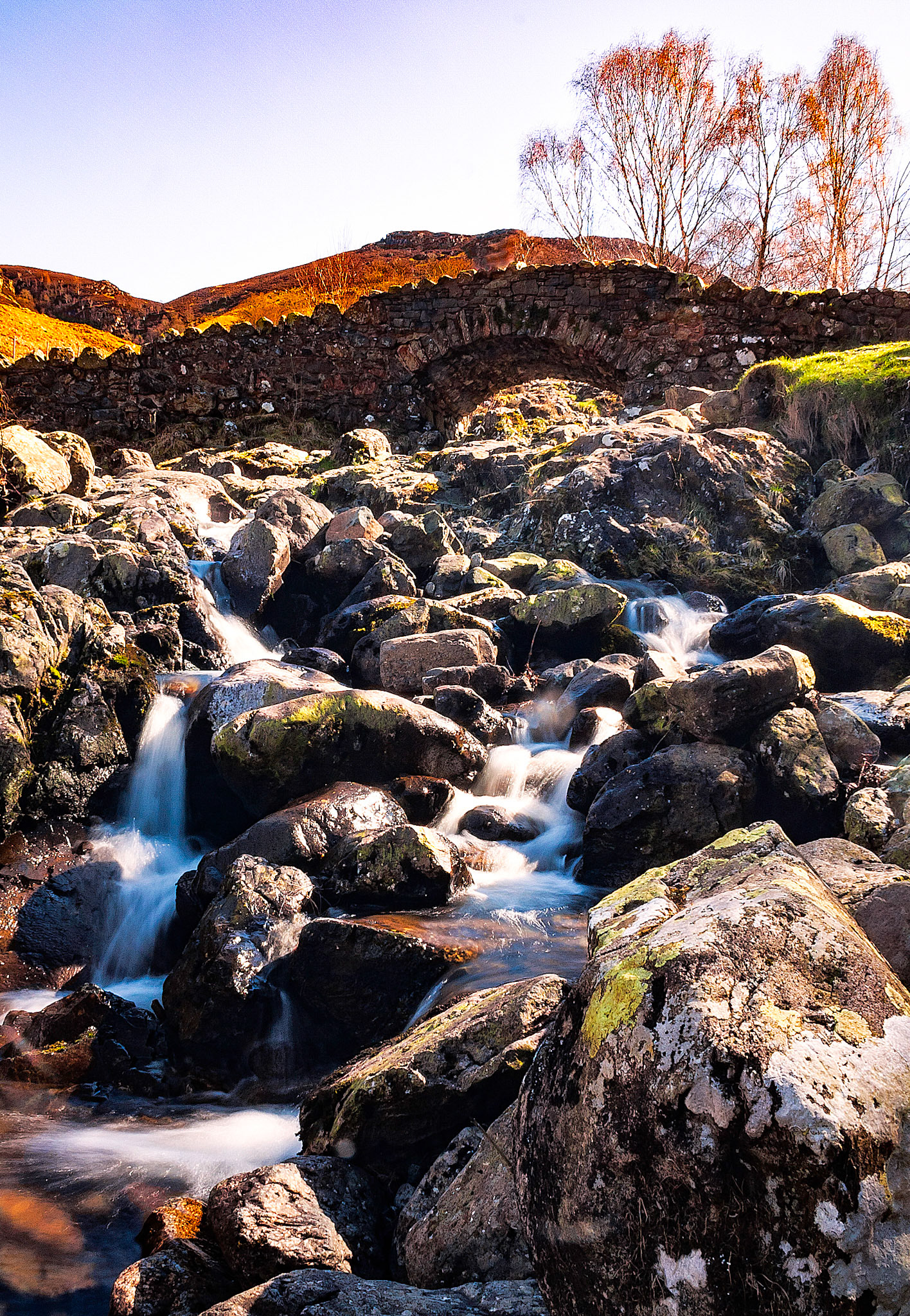 Wateer tumbles over rocks under Ashness Bridge in the English Lake District.