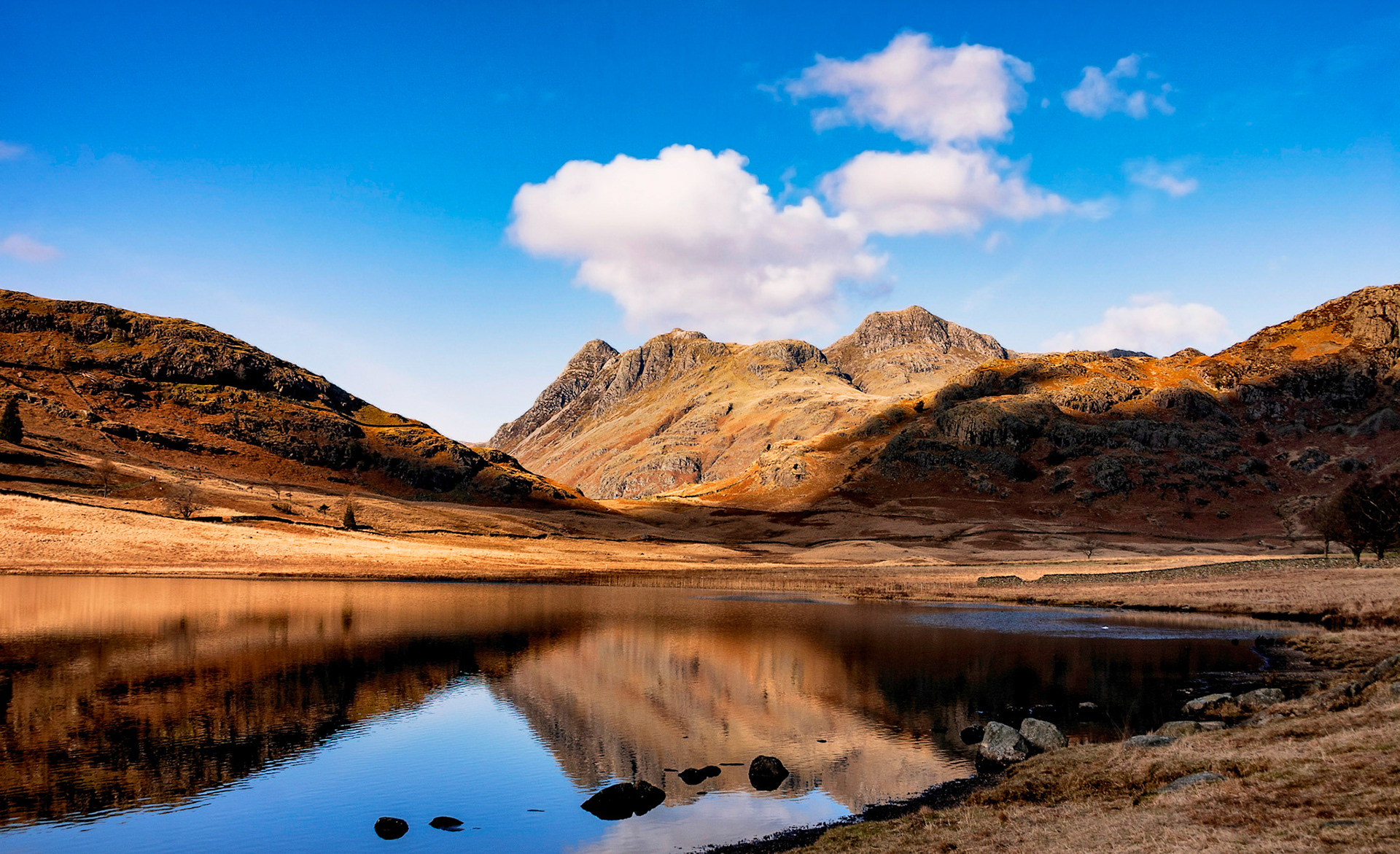 Blea Tarn between Great Langdale and Little Langdale in the English Lake District with the Langdale Pikes in the background.