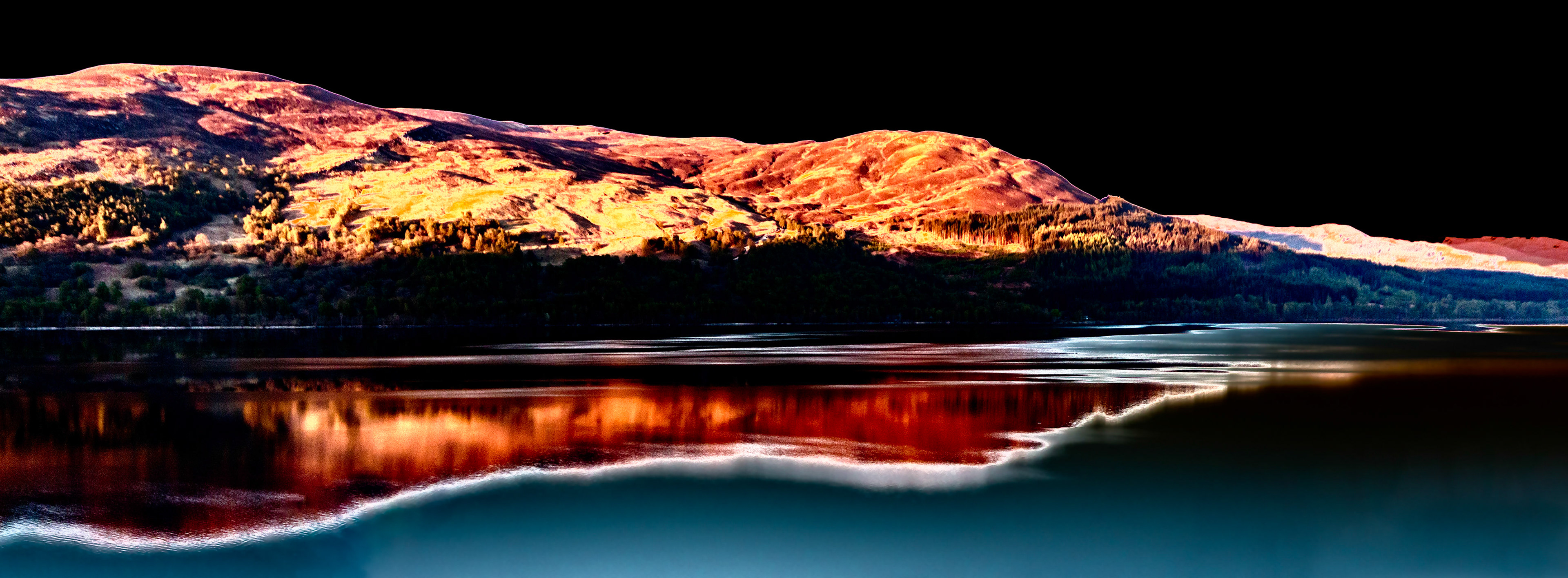 Loch Rannoch, Scotland.. Image created with a solarisation effect applied turning day into night and creating dramatic contrasting colours.