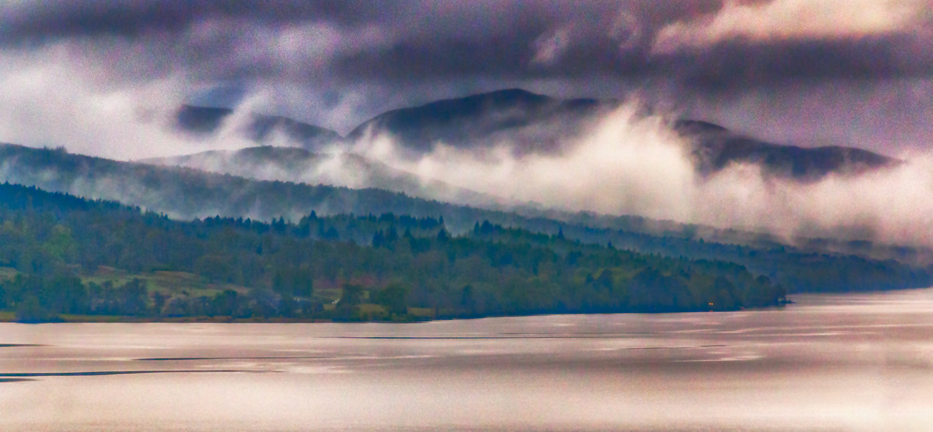 Early morning mist lifting from the mountain valleys around Loch Rannoch in Scotland.