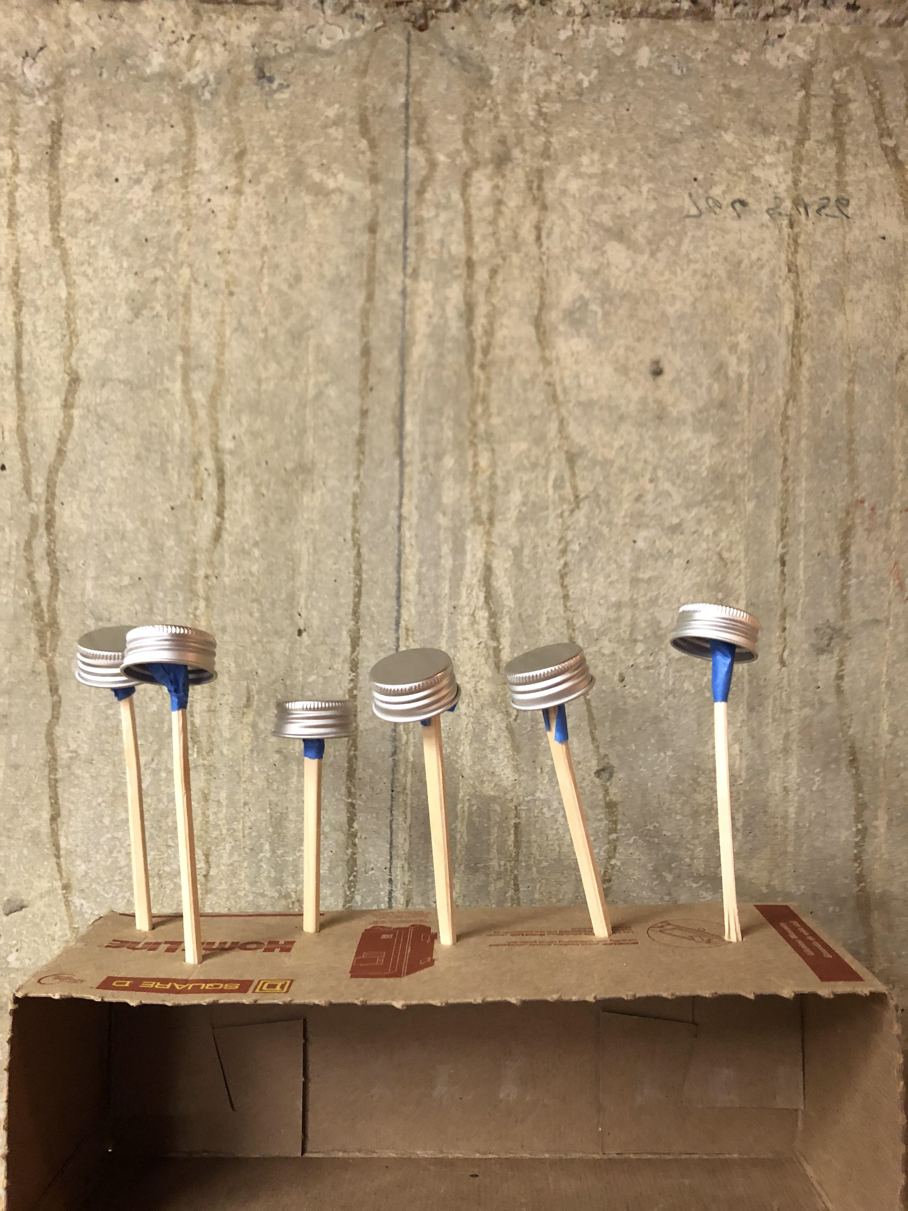 Spray painting caps to match black on packaging.