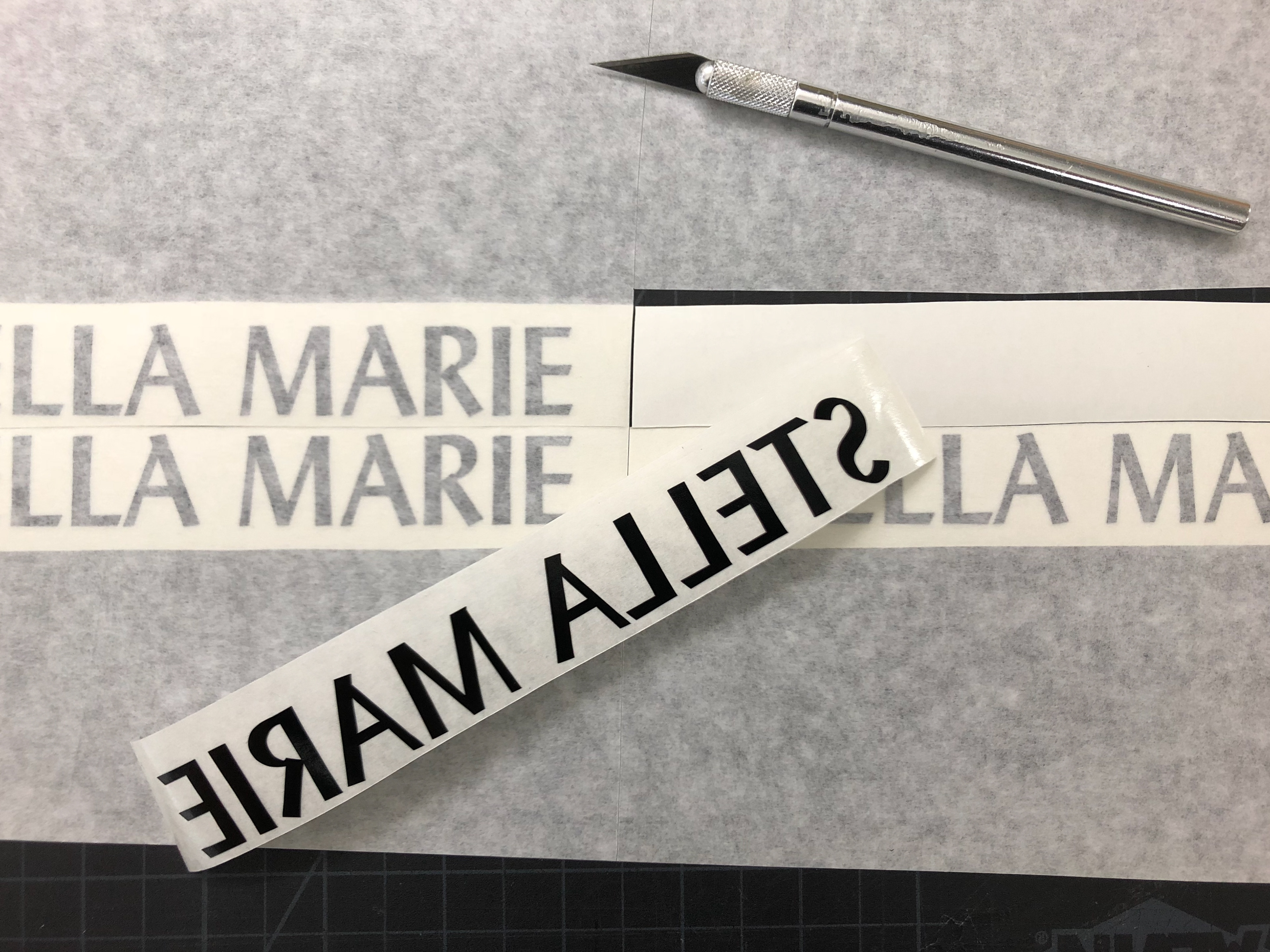 Prepping the vinyl logos to transfer onto form.