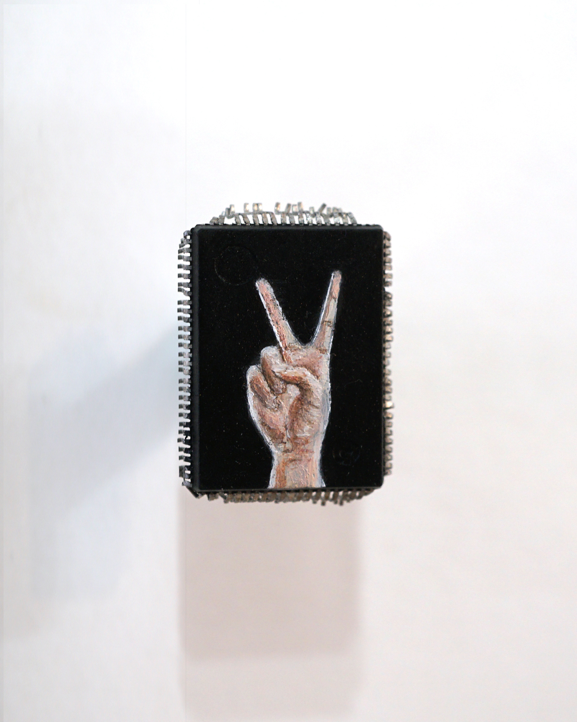 ✌🏻, oil on microchip, 2x1 cm