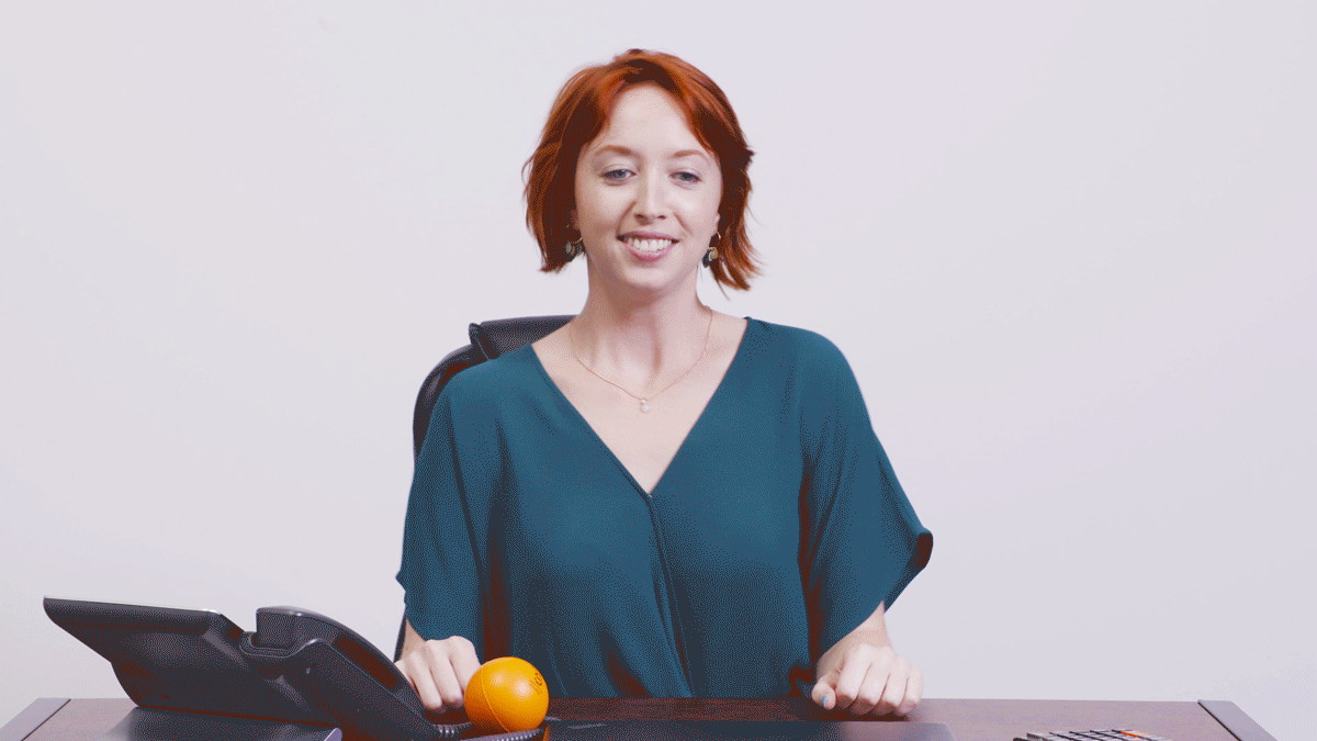 GIF of woman dancing and feeling relieved at desk