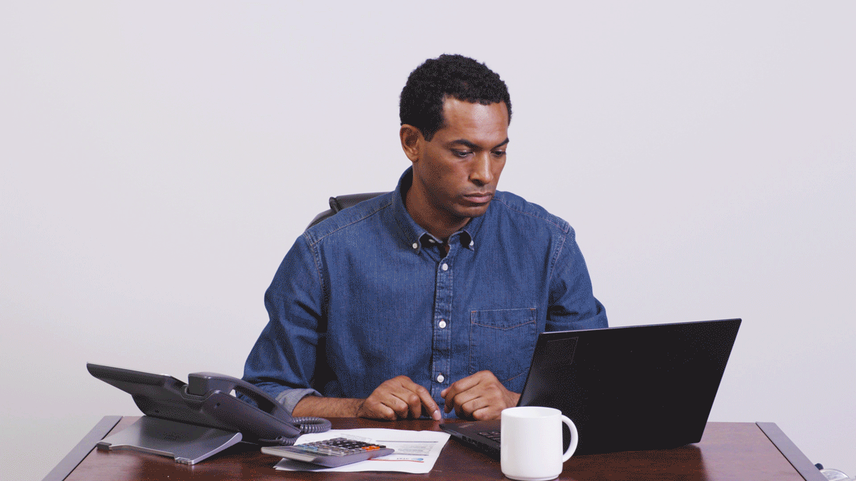 GIF of man frustrated and hitting items on desk