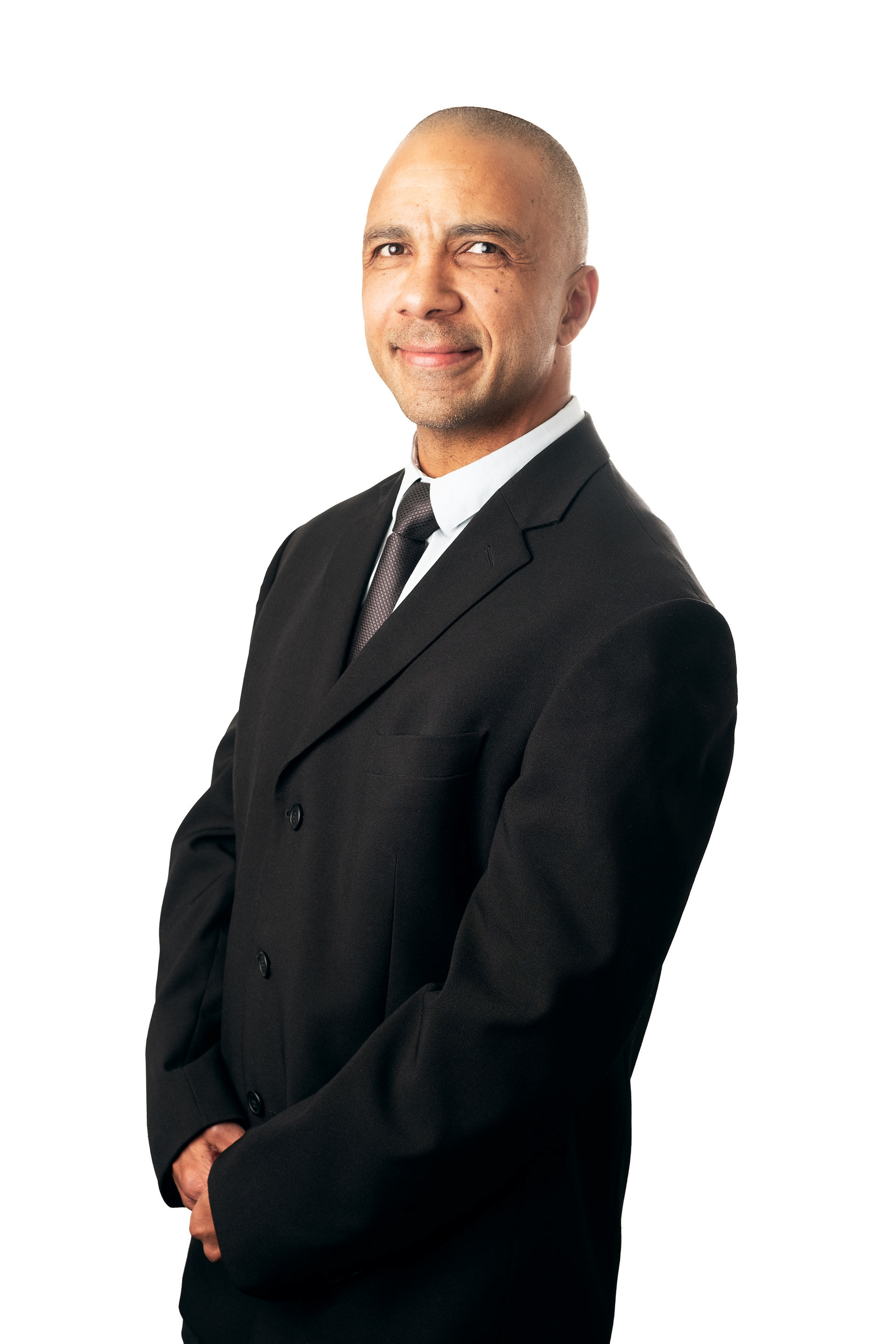 corporate headshot of a man in a suit against a white backdrop