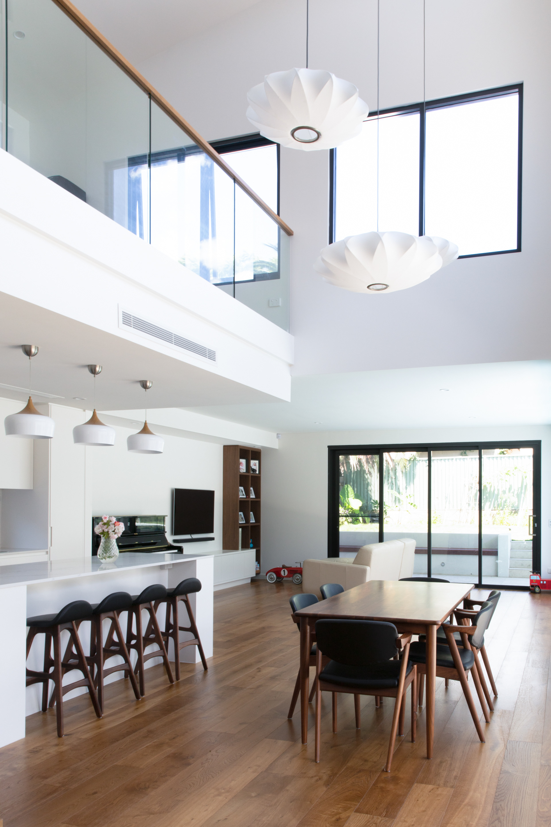 Raked ceiling, high clerestory windows orientated north dramatically infill natural light over the double height volume.