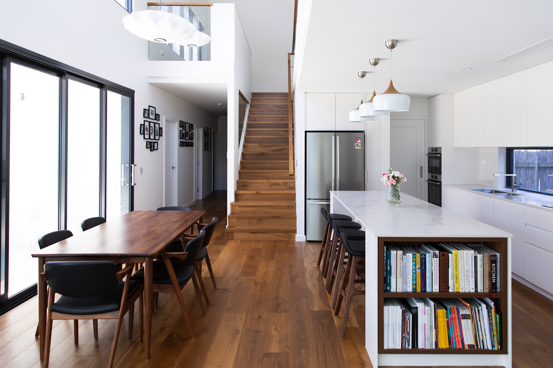 Natural light spills into the kitchen and dining area from the north facing sliding doors and clerestory windows over the double height space.