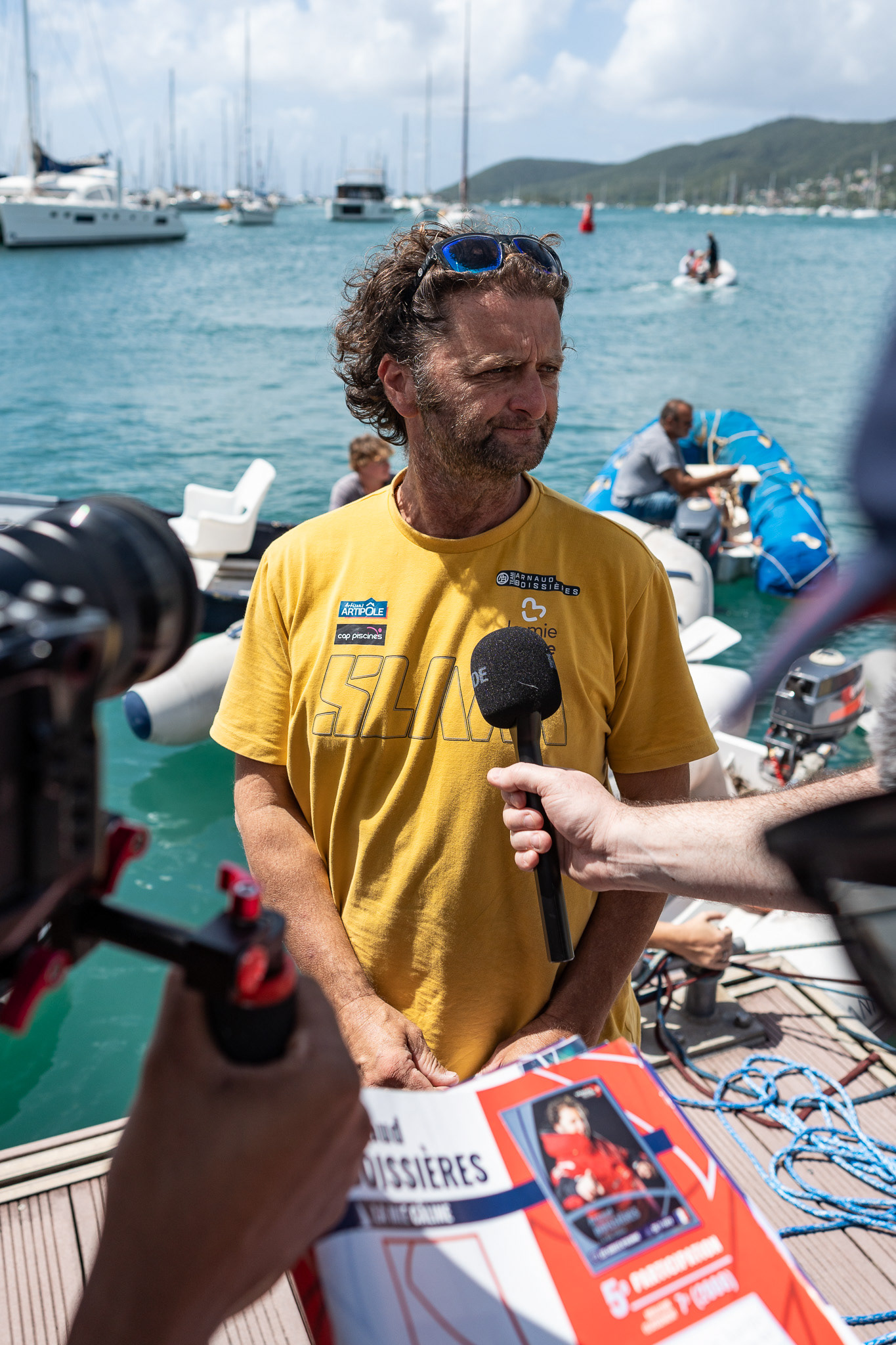 Boissieres is interviewed as a fan waits to ask for an autograph