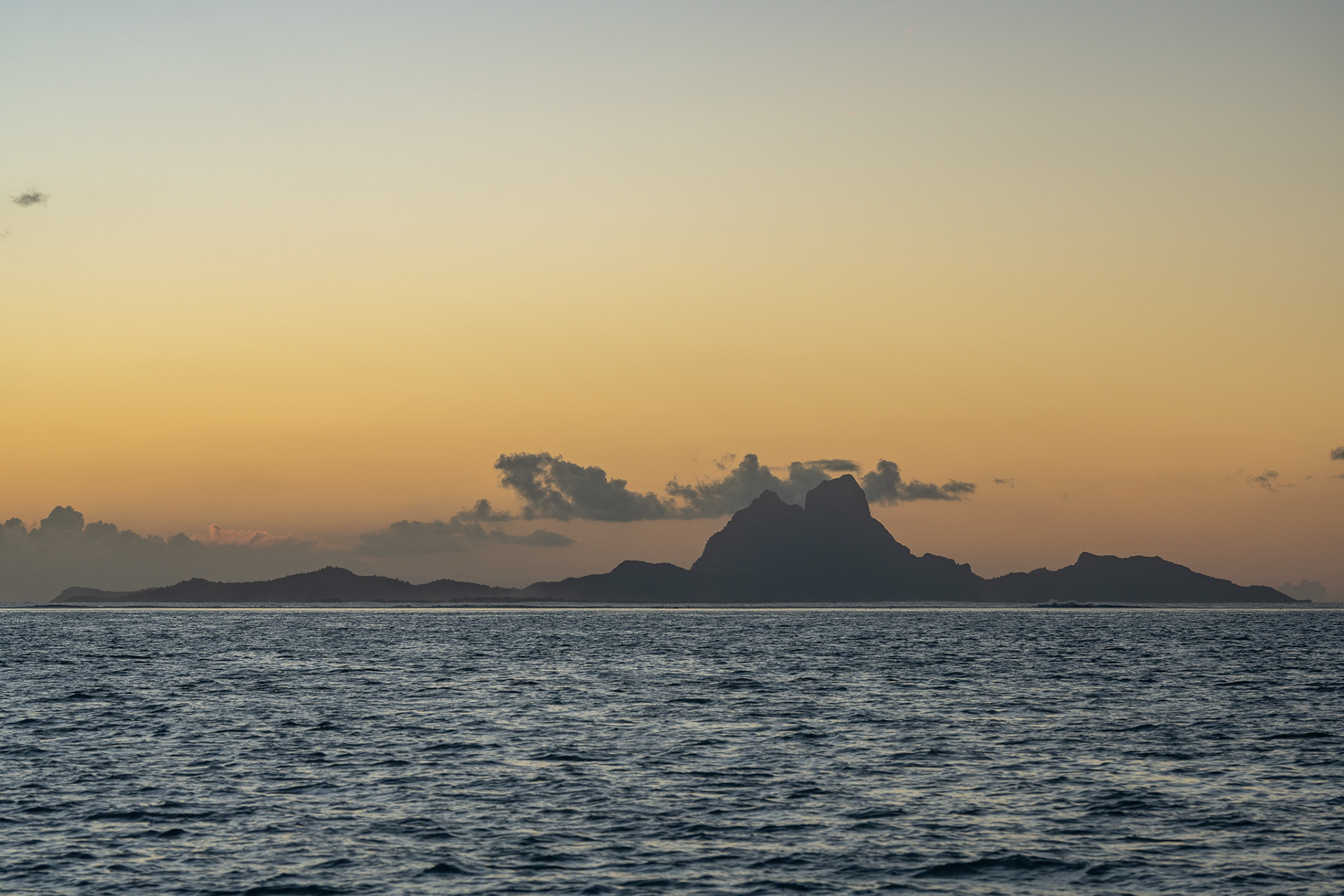 Bora Bora juts out in front of the golden sky