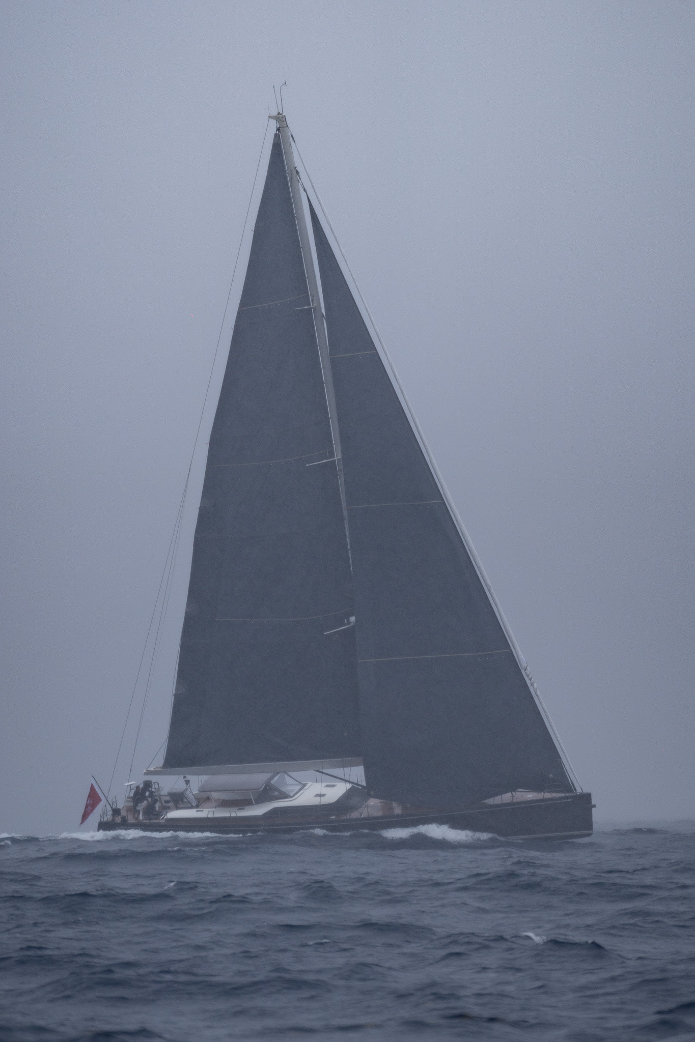 S/Y Black Pearl II hammers past us in a storm between Martinique ad Dominica