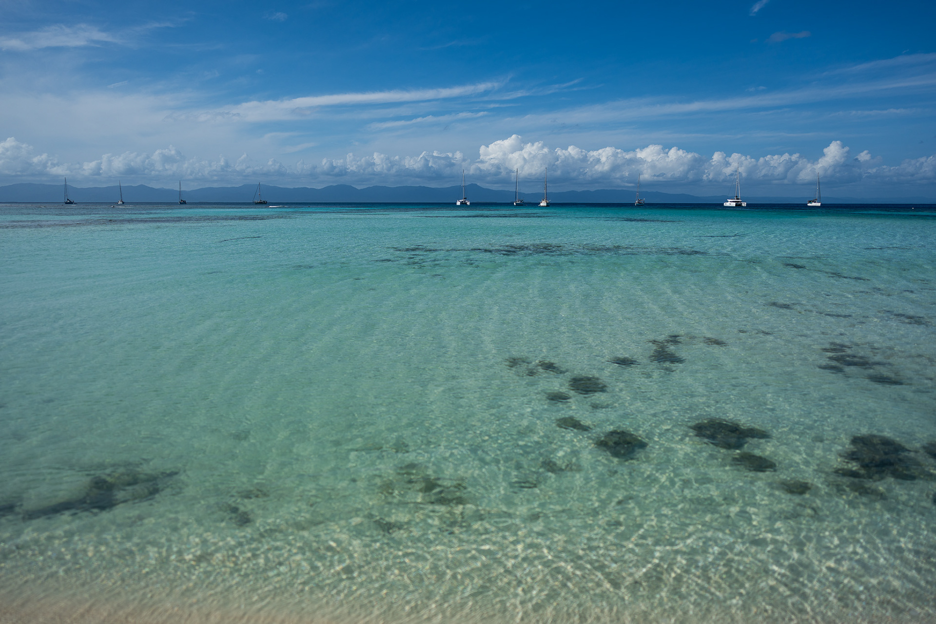 Crystal-clear, green water leads back towards the mainland of Panama