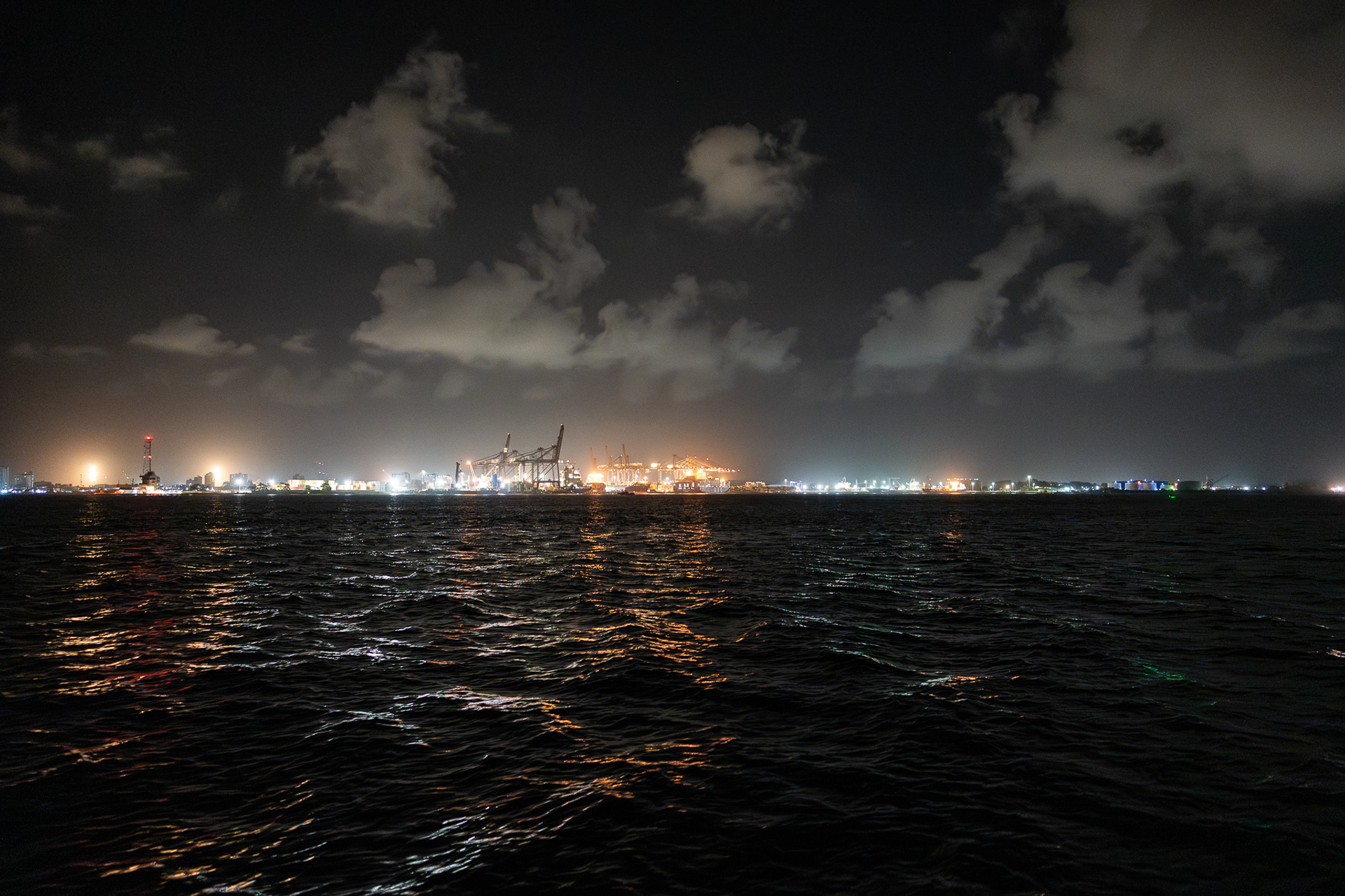 The lights of Colon cut through the early 3am darkness as our adventure across the Panama Canal commences