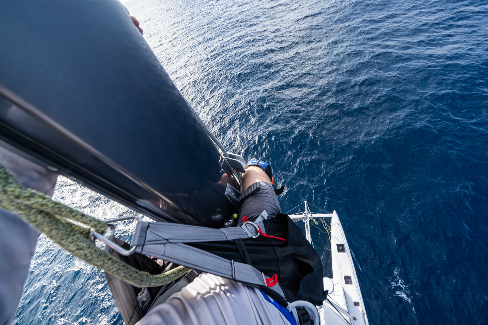 Gripping the mast for dear life as the swell throws me around