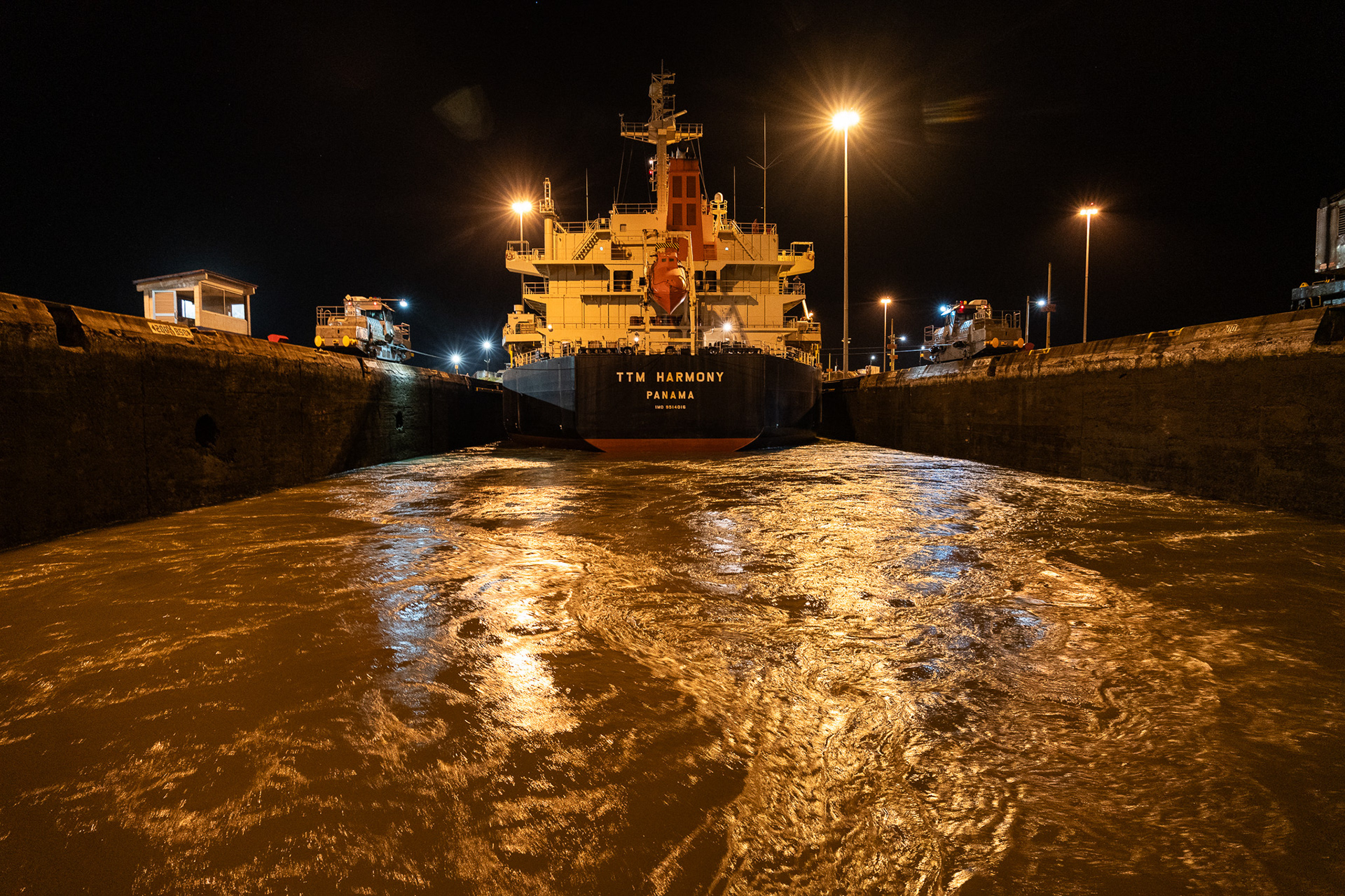 Water swirls as it rushes into the canal lock, raising boats up to the level of Gatun Lake