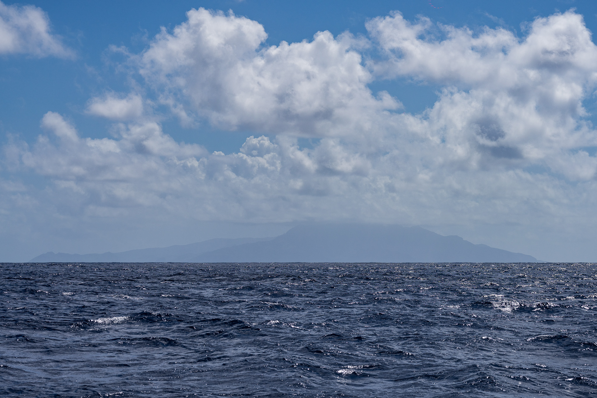 Land ho! Ua Huka appears out of the distance some 20 miles in front of us