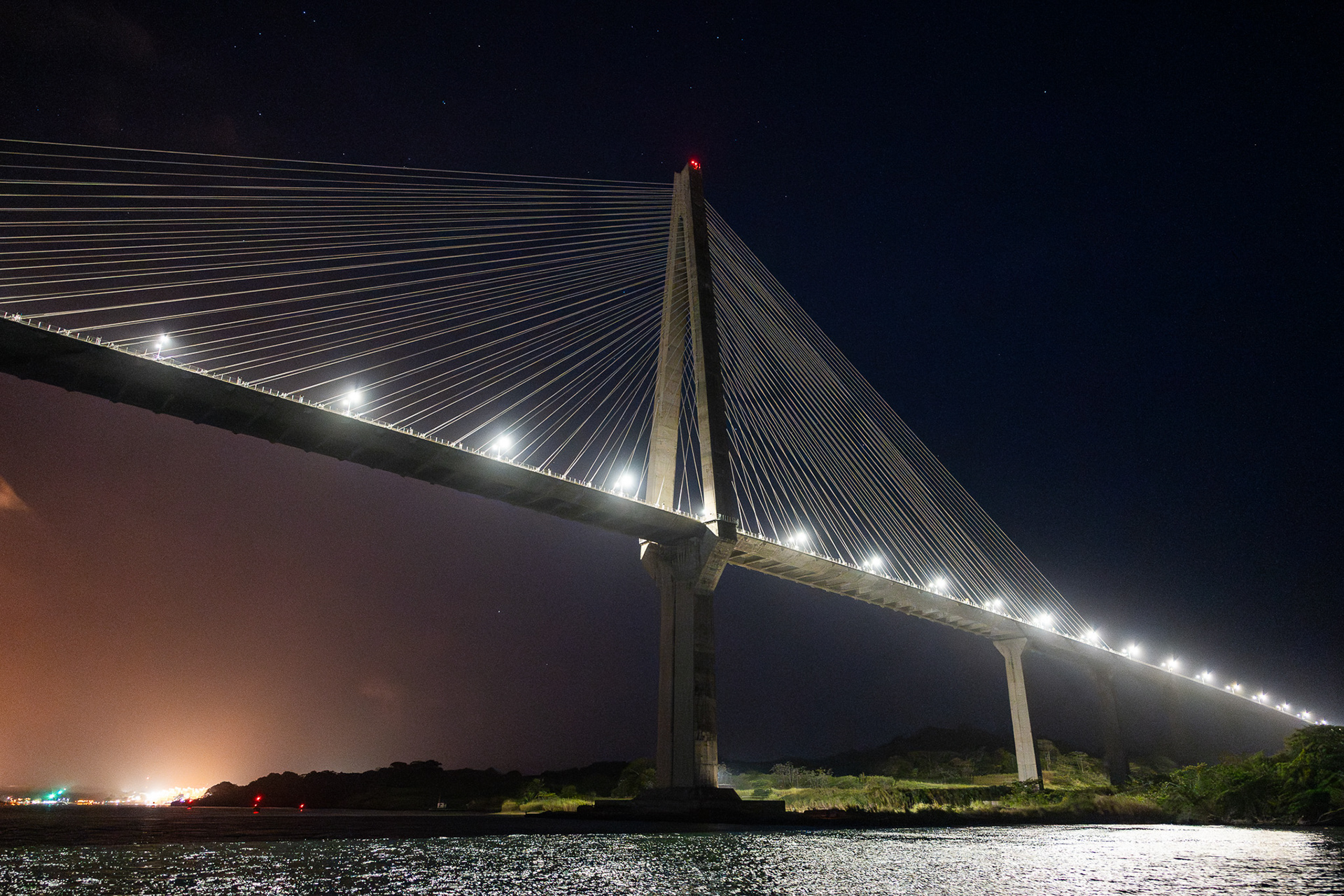 Crossing under the Puente Atlántico with the glow of the canal off in the distance