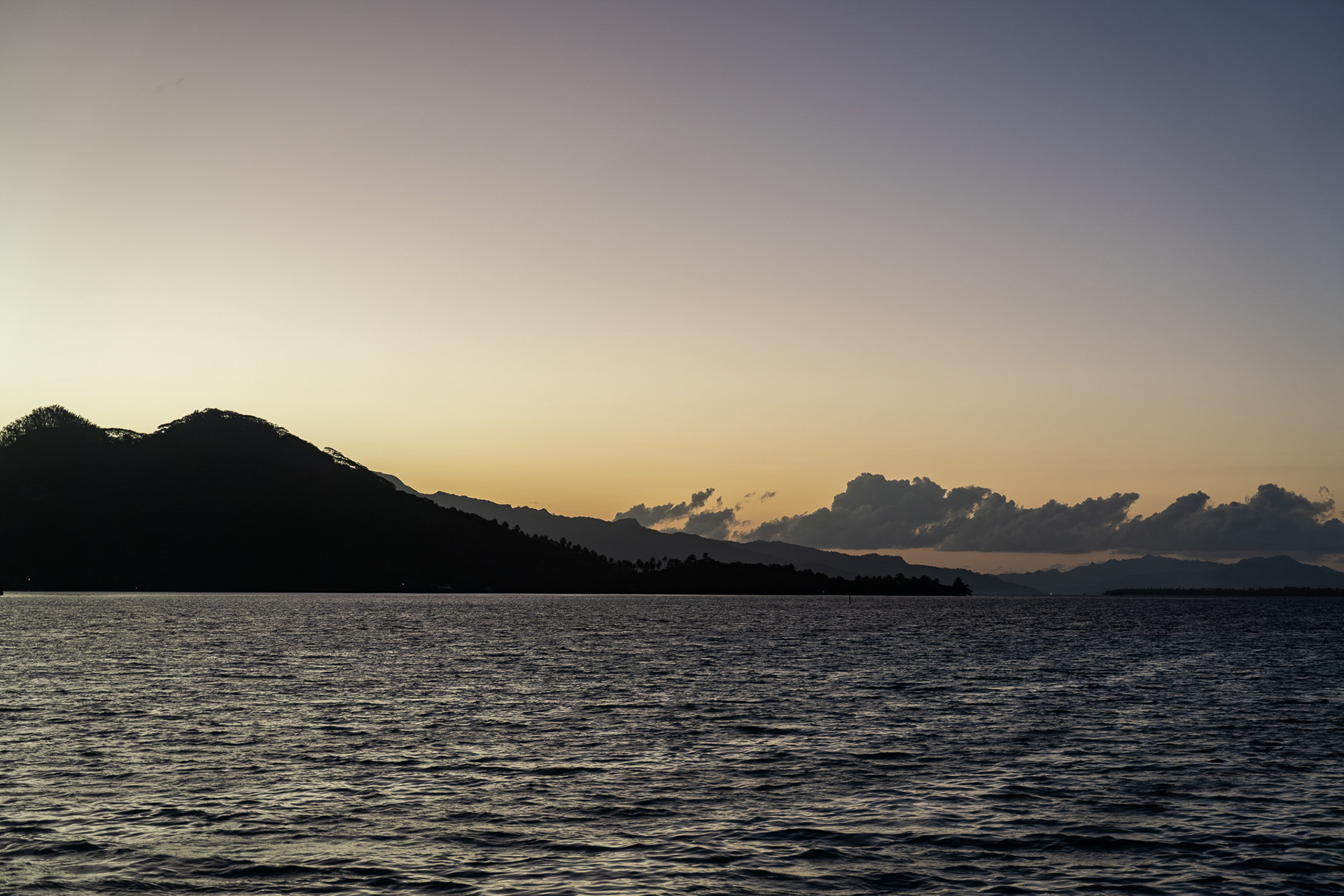 Golden hour dims to a soft blue in Raiatea