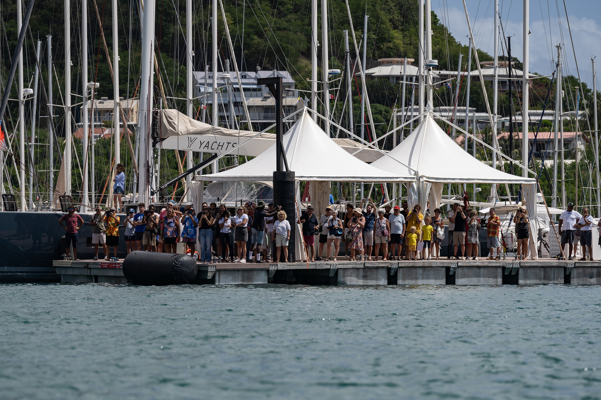 A crowd gathers at the dock in Le Marin