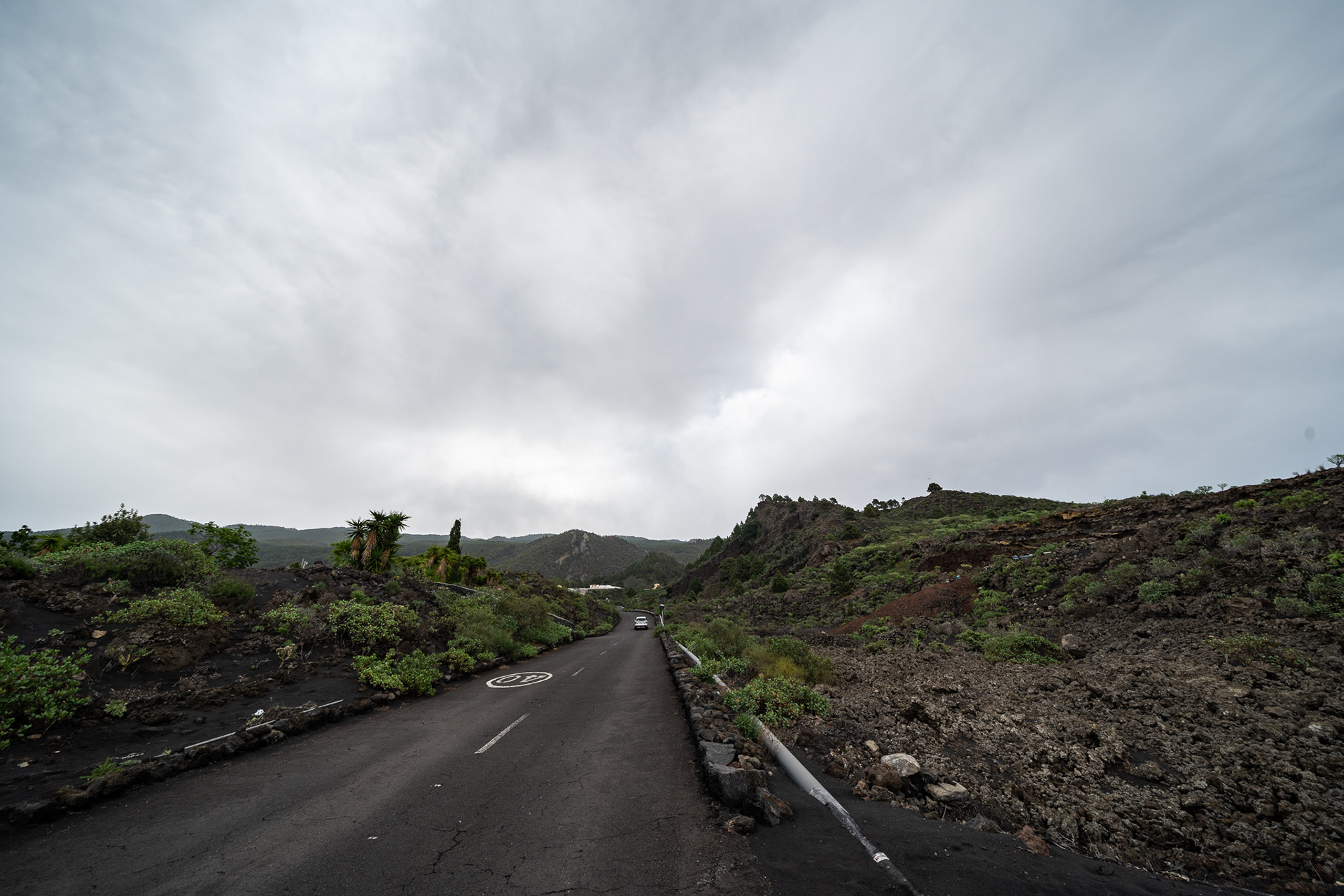 A freshly paved road cuts through the lava flow on the west side of the island