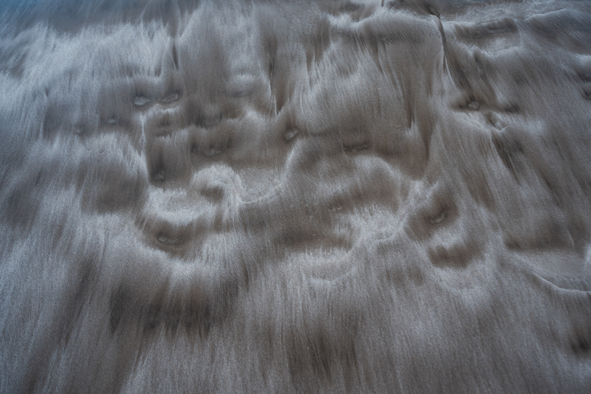 The dark, marbled volcanic sand