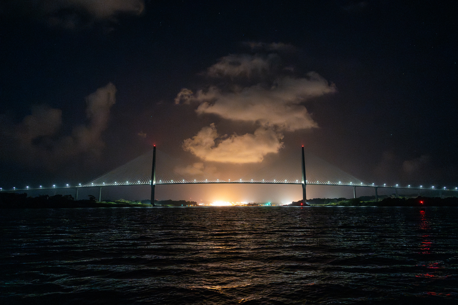 Despite a 3am wake-up call, the Gatun Lock lighting shines bright like a sunrise, with the Puente Atlantico in front