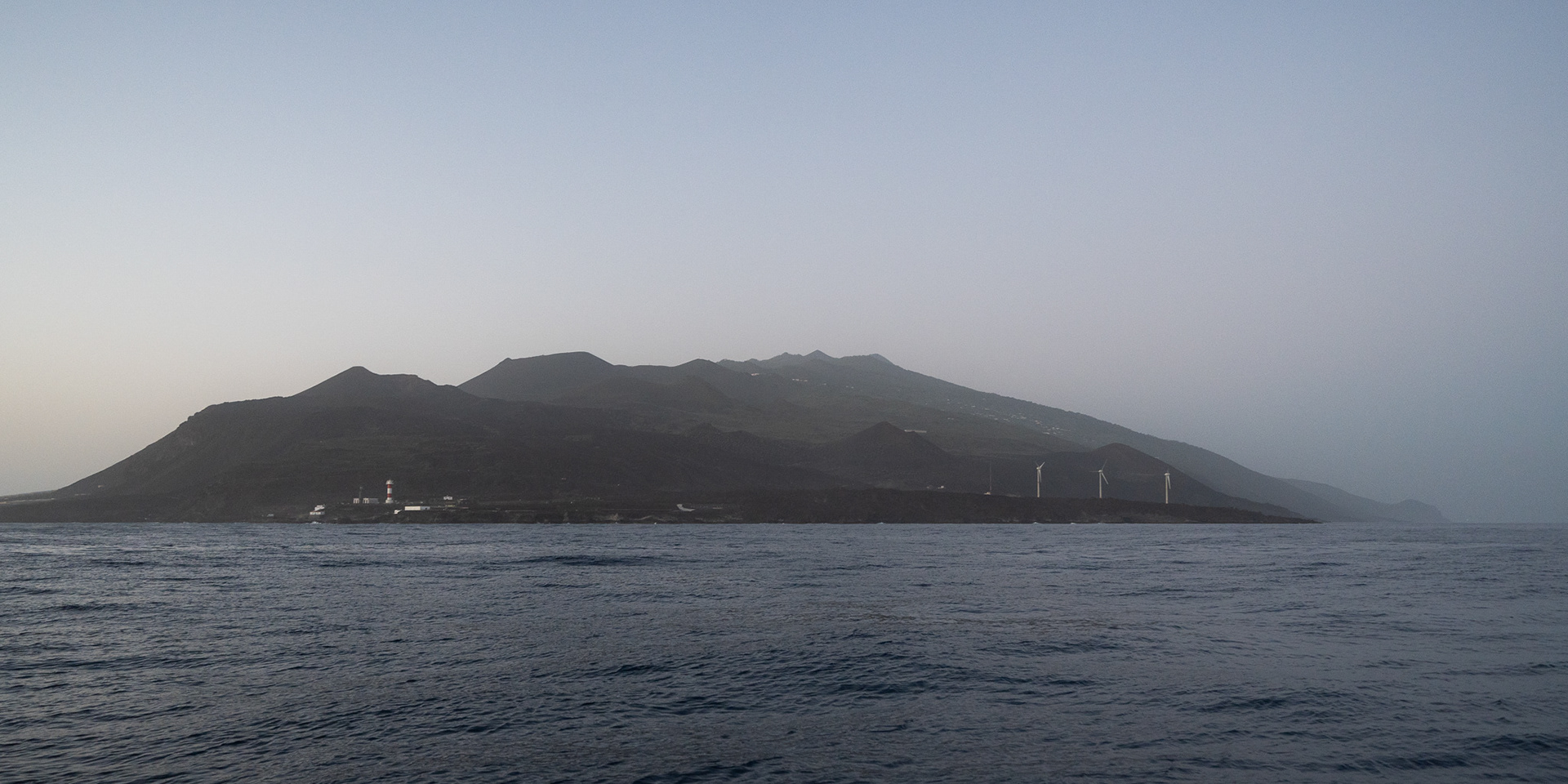 Passing by a hazy south tip of La Palma right as the sun dips below the horizon