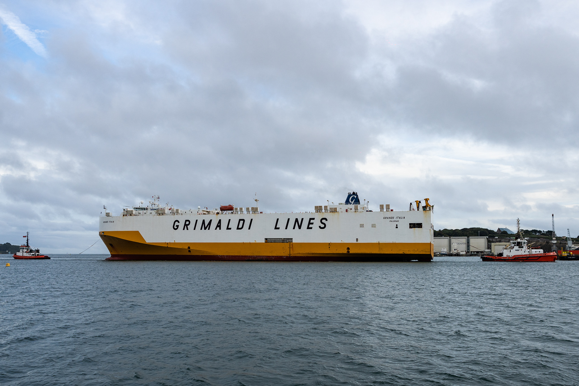 Cruise ships weren't the only giants going in and out of the port. Here, a 177m (600ft) ship is guided in with the help of two tugs