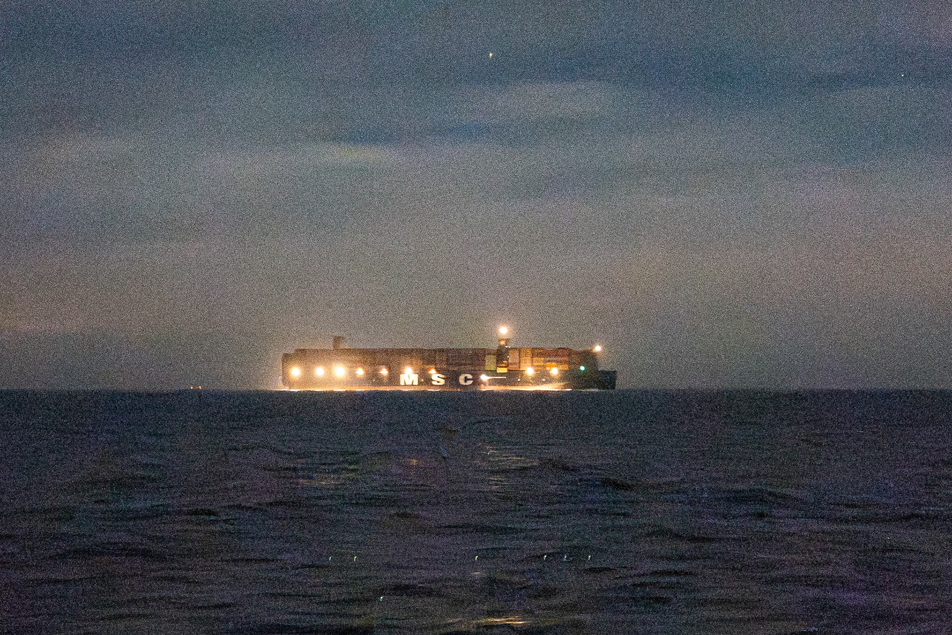 The quarter-mile-long MSC Raya passes us to port