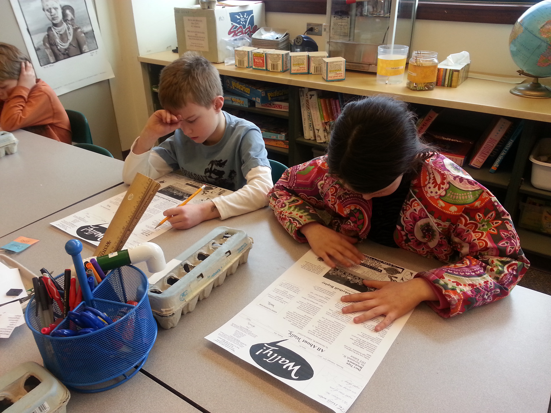 A reporter and I read over our first printed issue for typos.