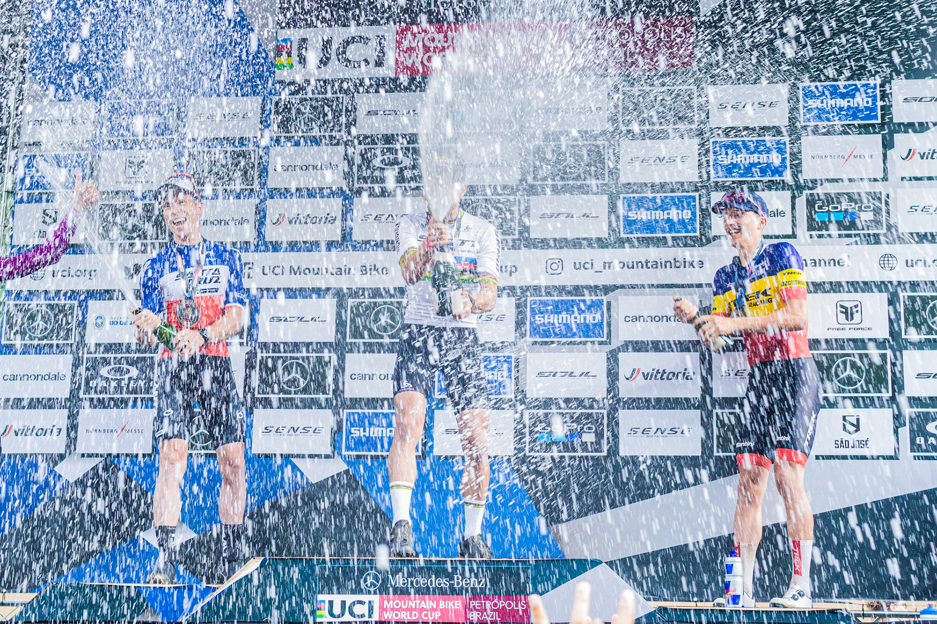 The top three in the XCO of the MTB World Cup in Petrópolis, Nino Schurter, Maxime Marote and Vlad Dascalu, celebrate the result on the podium - Petrópolis, Brazil - April 10, 2022.