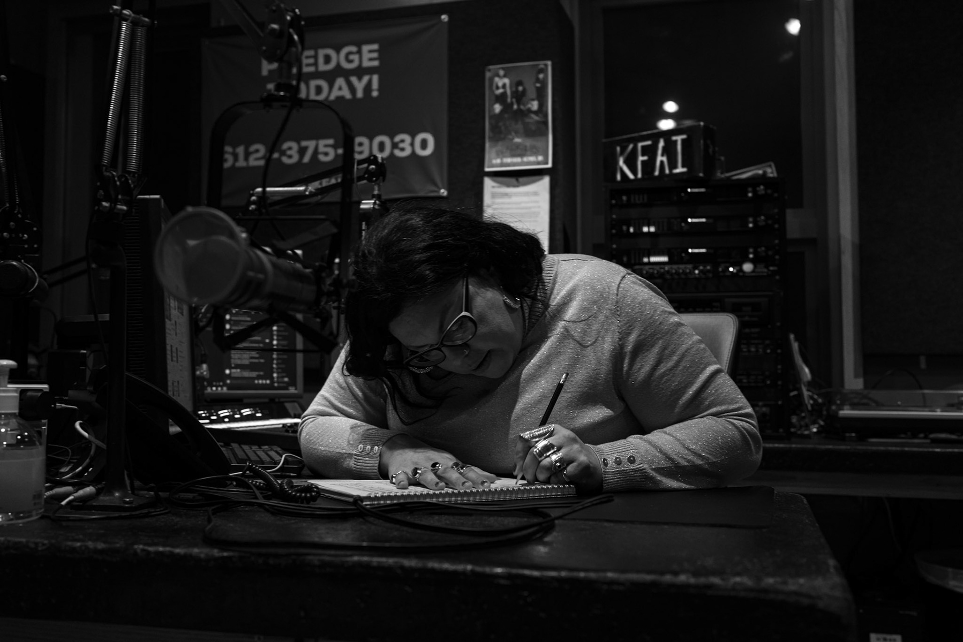 Between segments Quinn adds to her notes. The research never stops.