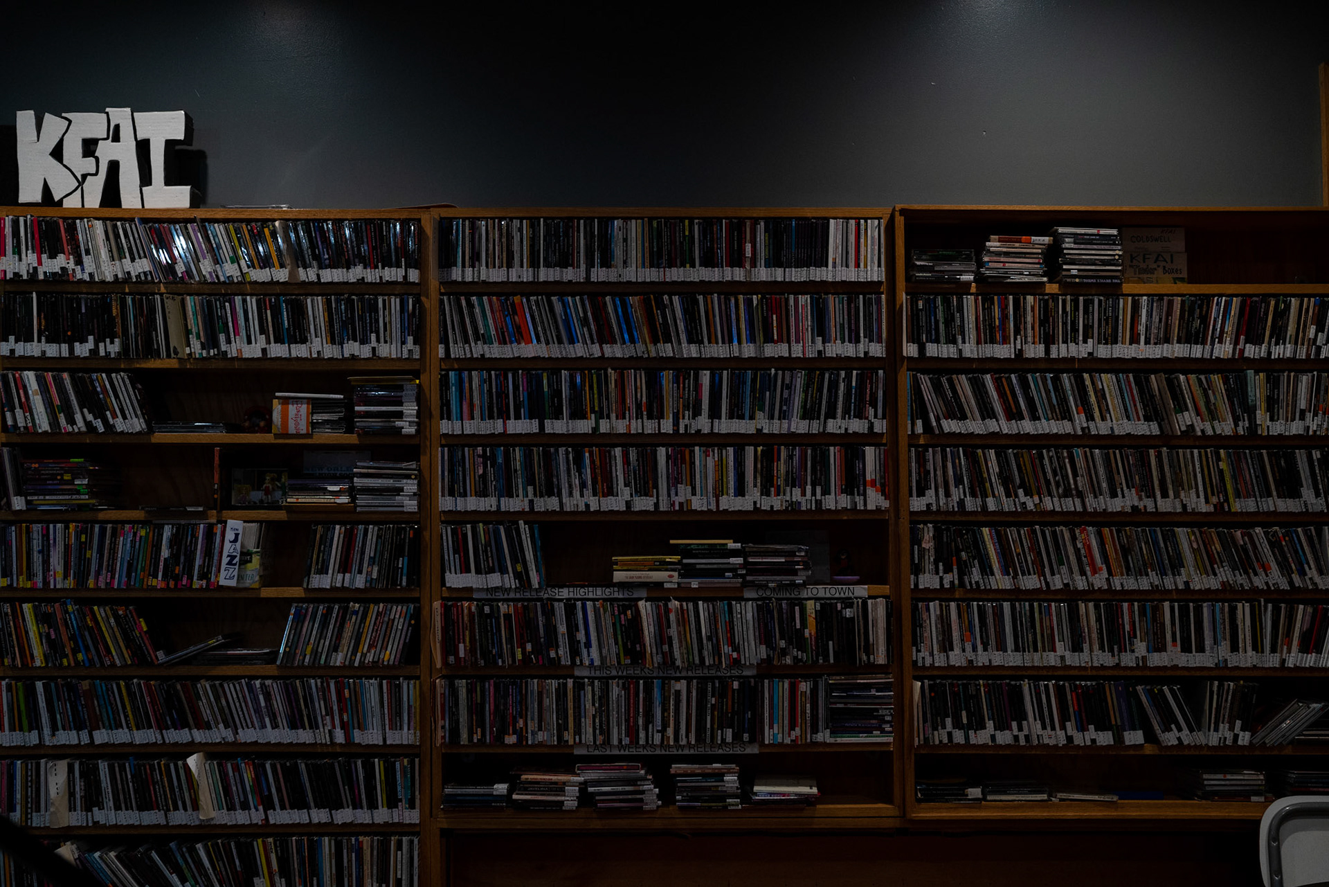 A wall dedicated to a by-gone era. CD's fill the shelves in the KFAI Radio Booth.