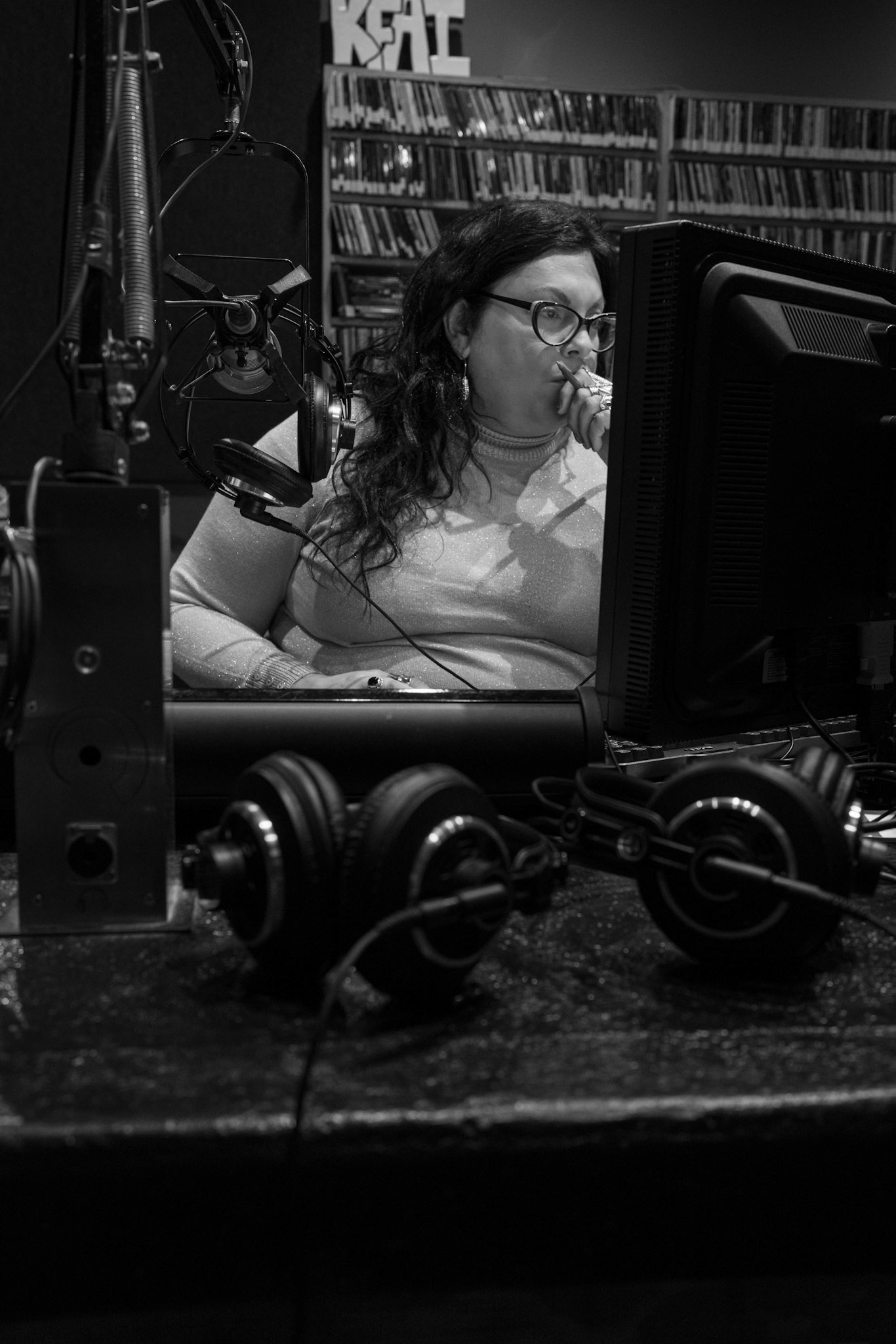 Alone in the studio. Quinn preps the music, ads, and organizes her thoughts.