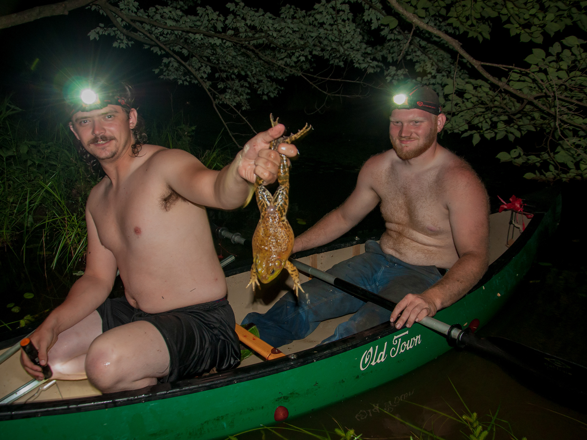 Giggers pose with large frogs that they collected during the gig.