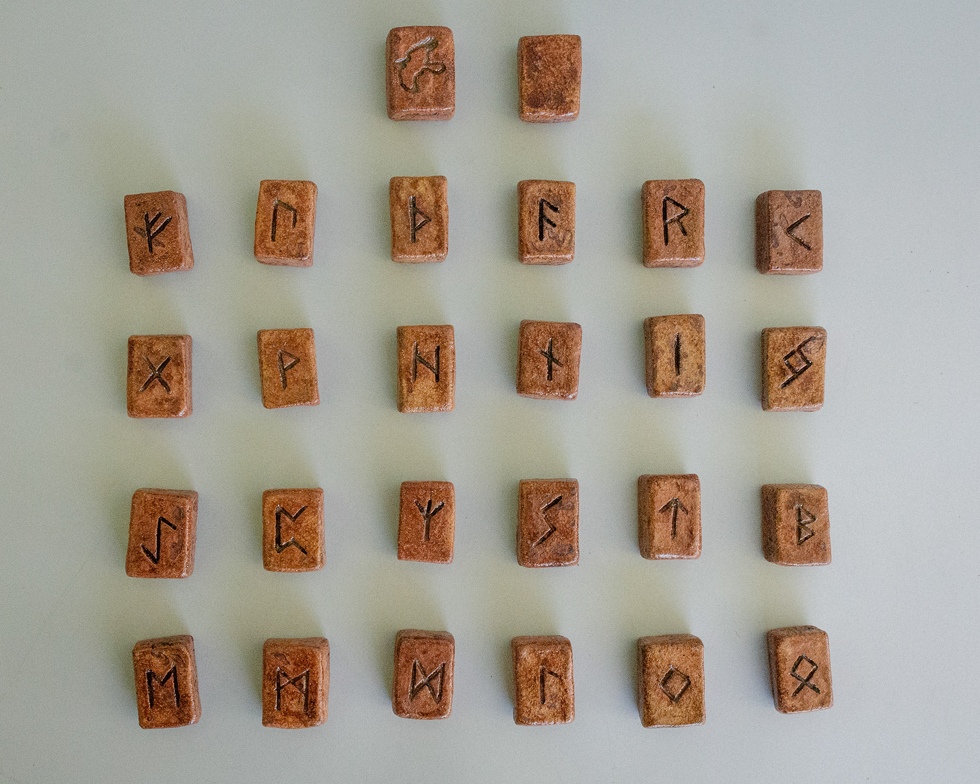 Elder Futhark Rune Stones & Raven stone (2024) Buff Raku Trachyte with Red Iron Oxide & porcelaine paint 2cm (W) x 1cm (H)