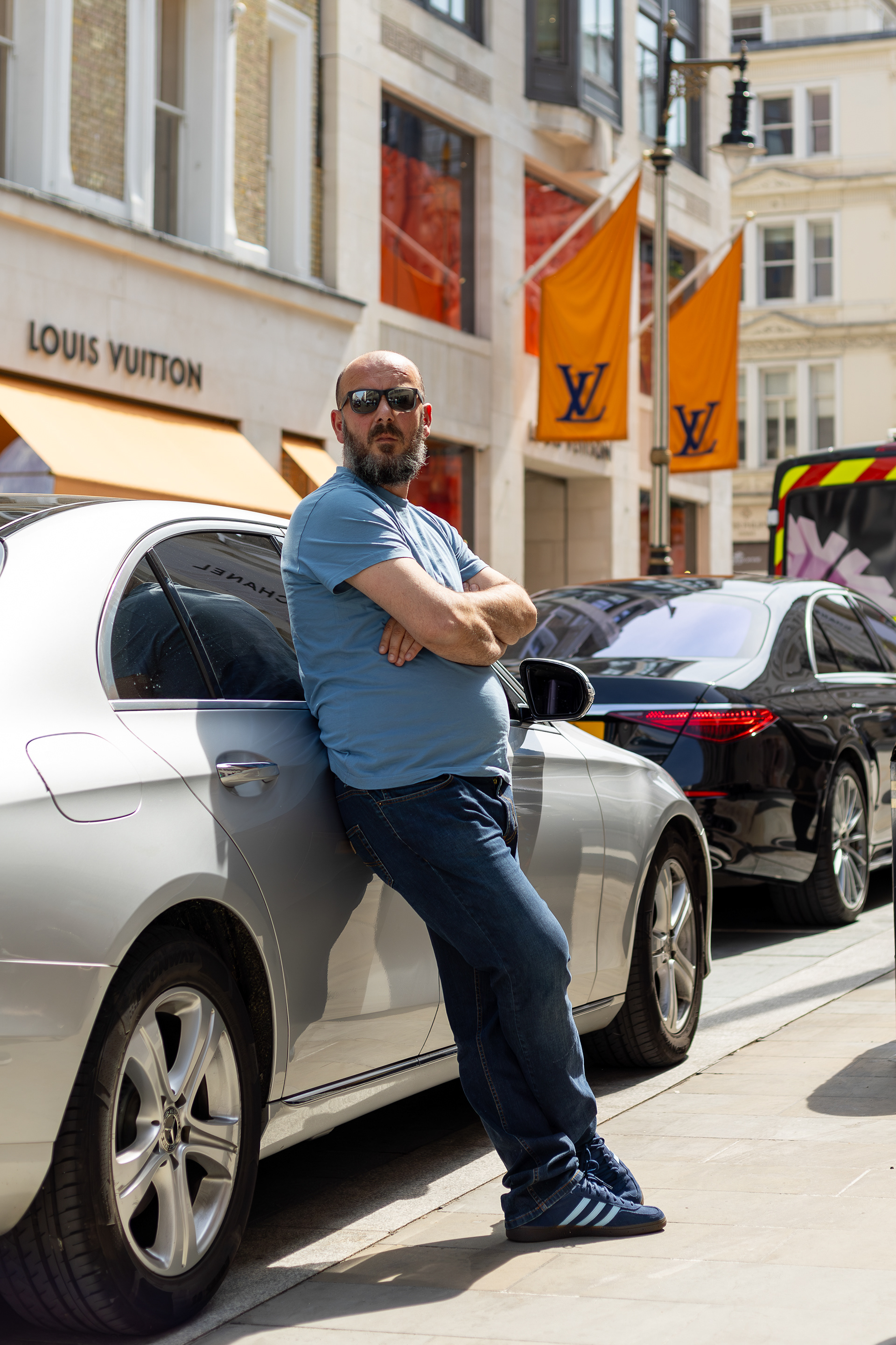 Mayfair London, man leaning on his car