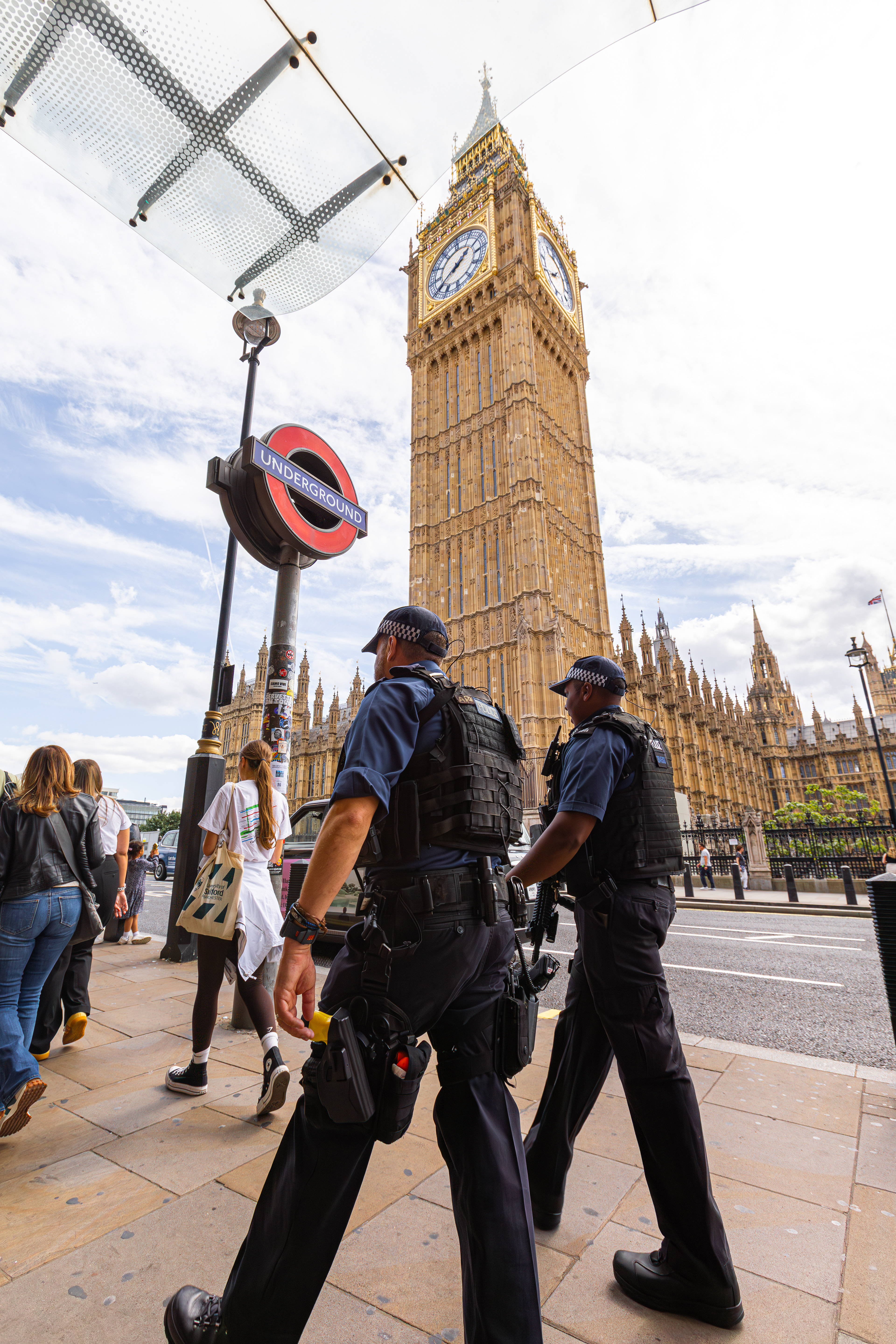 Policemen walking past big ben, Westminster London