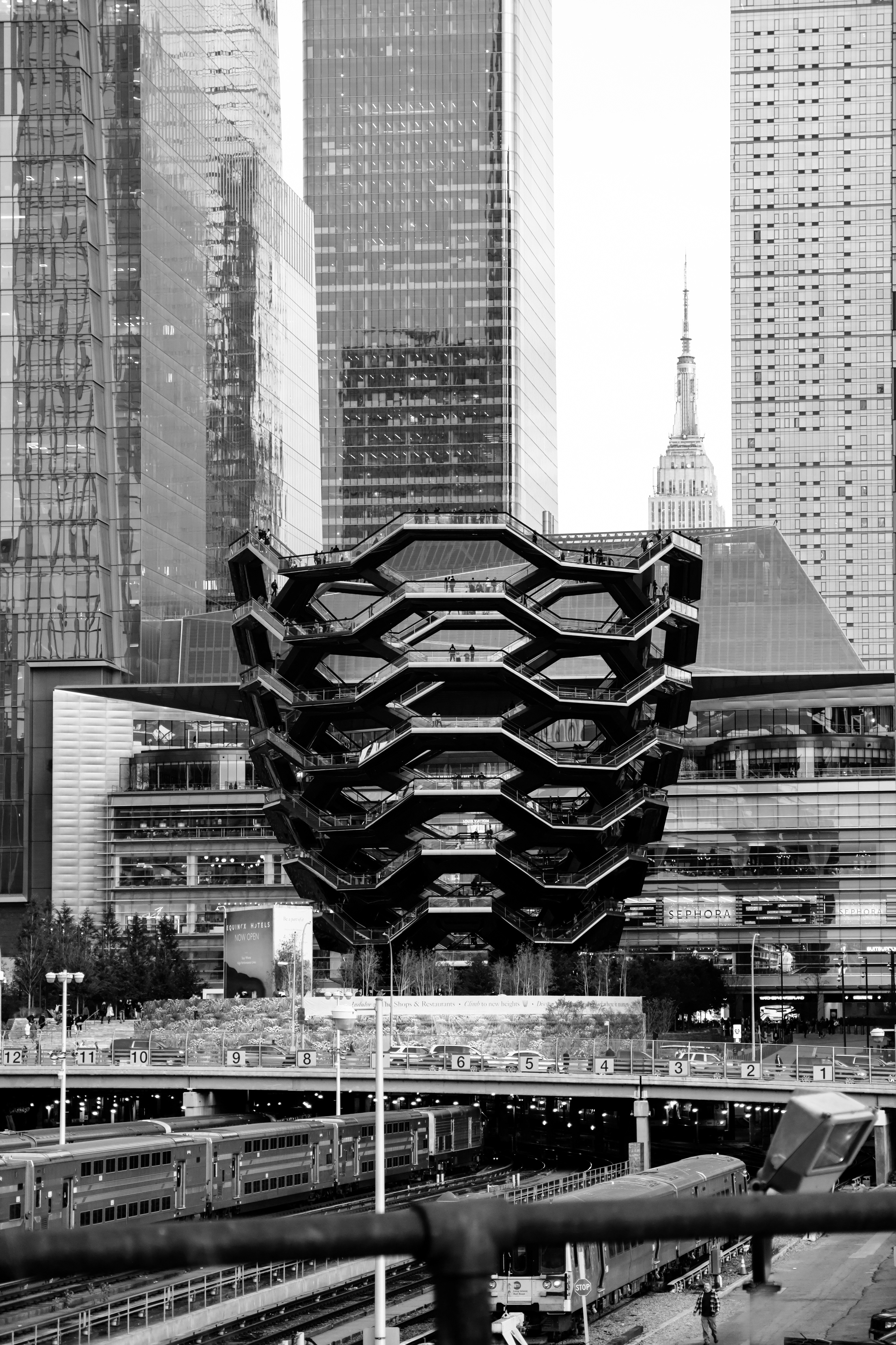 In this image it shoes The Vessel, The Empire State Building and the Train Yards in Black and White.