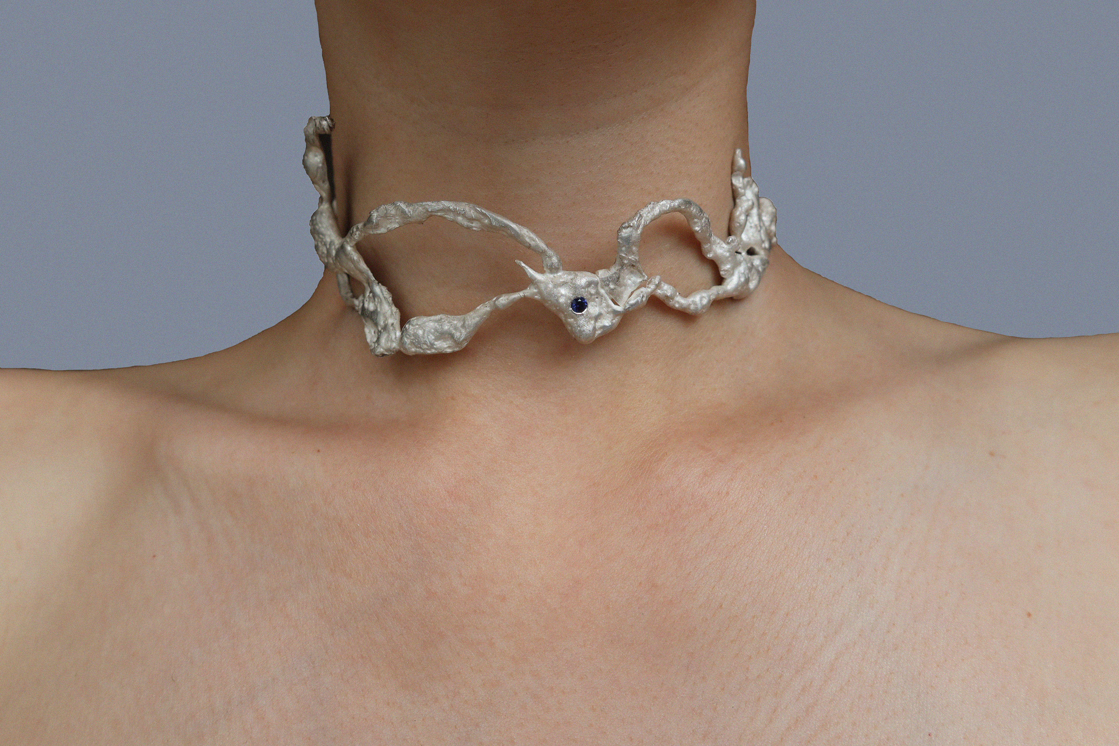 Earth cast silver choker with sapphire. Front view