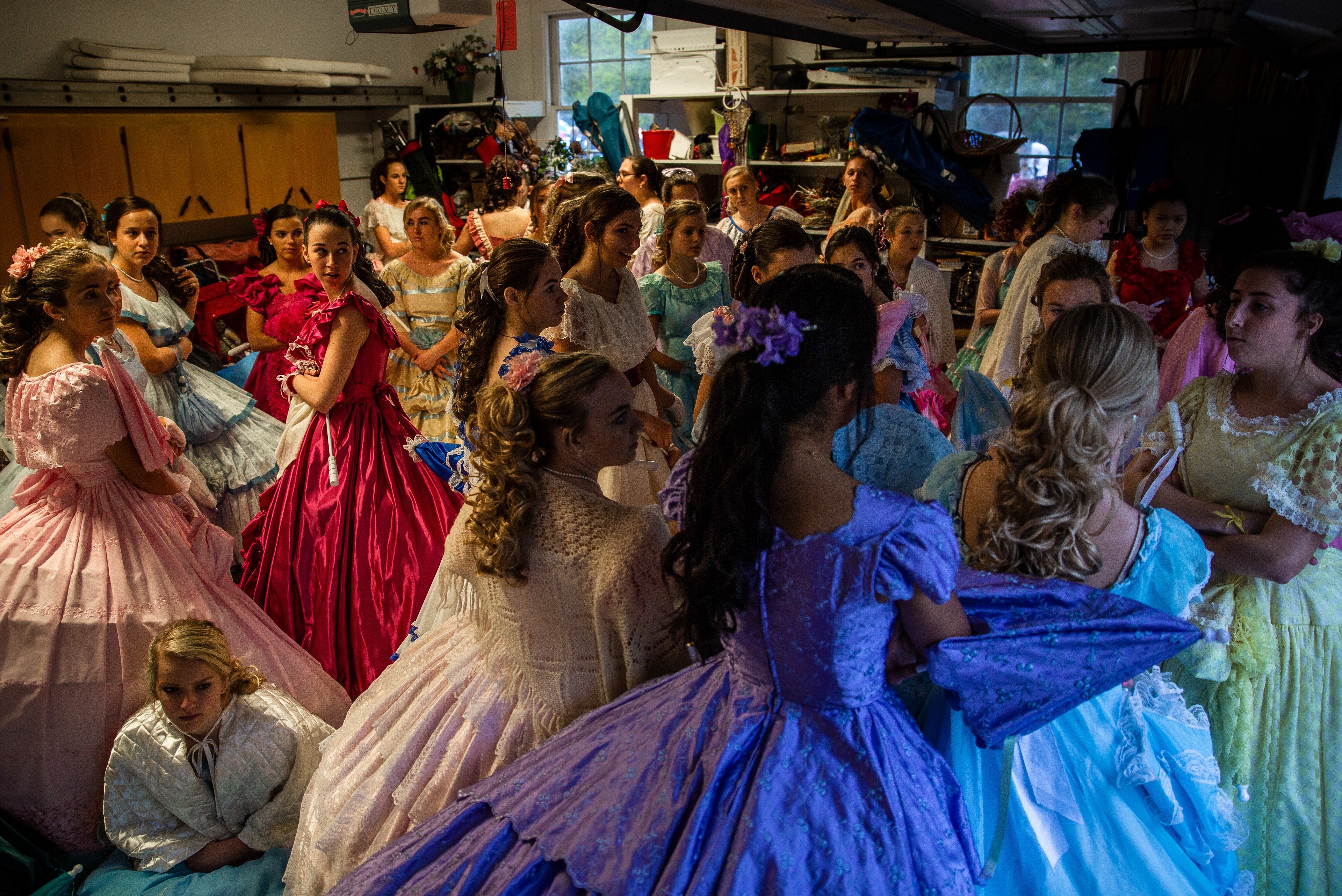 Azalea Belles take cover from the rain before the Cape Fear Garden Club Ribbon Cutting at the home of Steve and Linda Smits on Friday April 5, 2019 in Wilmington, N.C