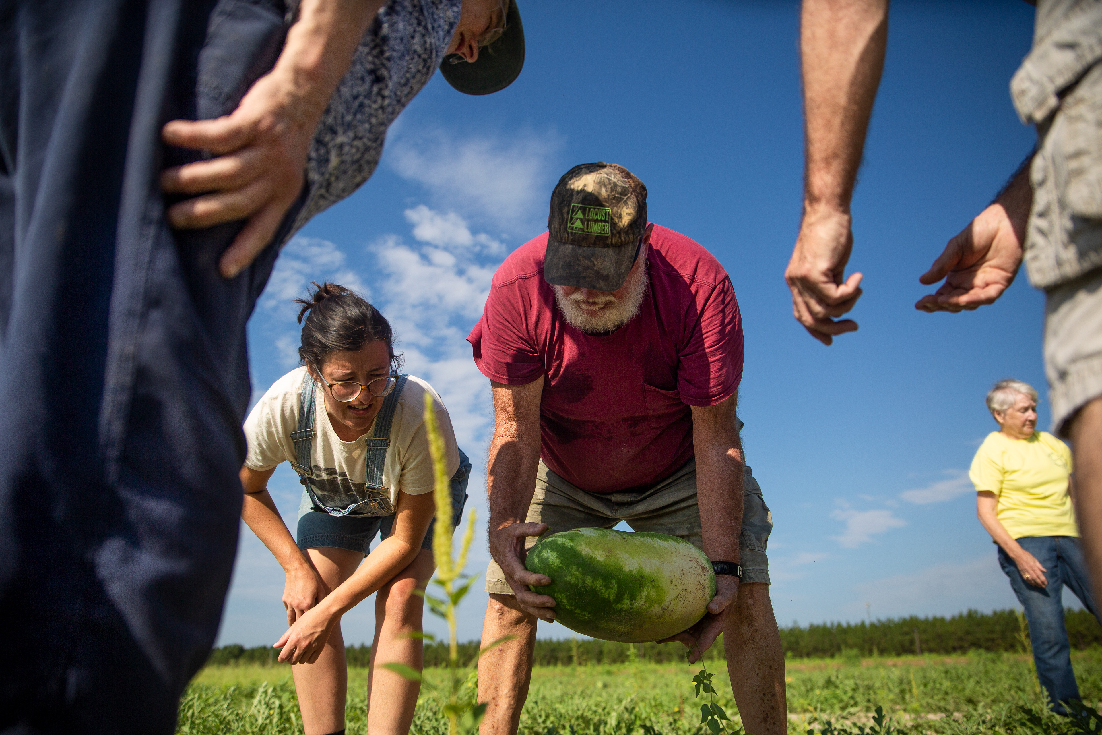 Volunteers harvest ripe watermelon at God's Garden Farm on July 19, 2019 in Norman, N.C. 325 lbs. of broccoli, 665 lbs. of squash, 5,100 lbs. of green beans, 4,200 pounds of corn, 3,700 pounds of peas, and 9,835 pounds of watermelon were produced for the 2019 season. 