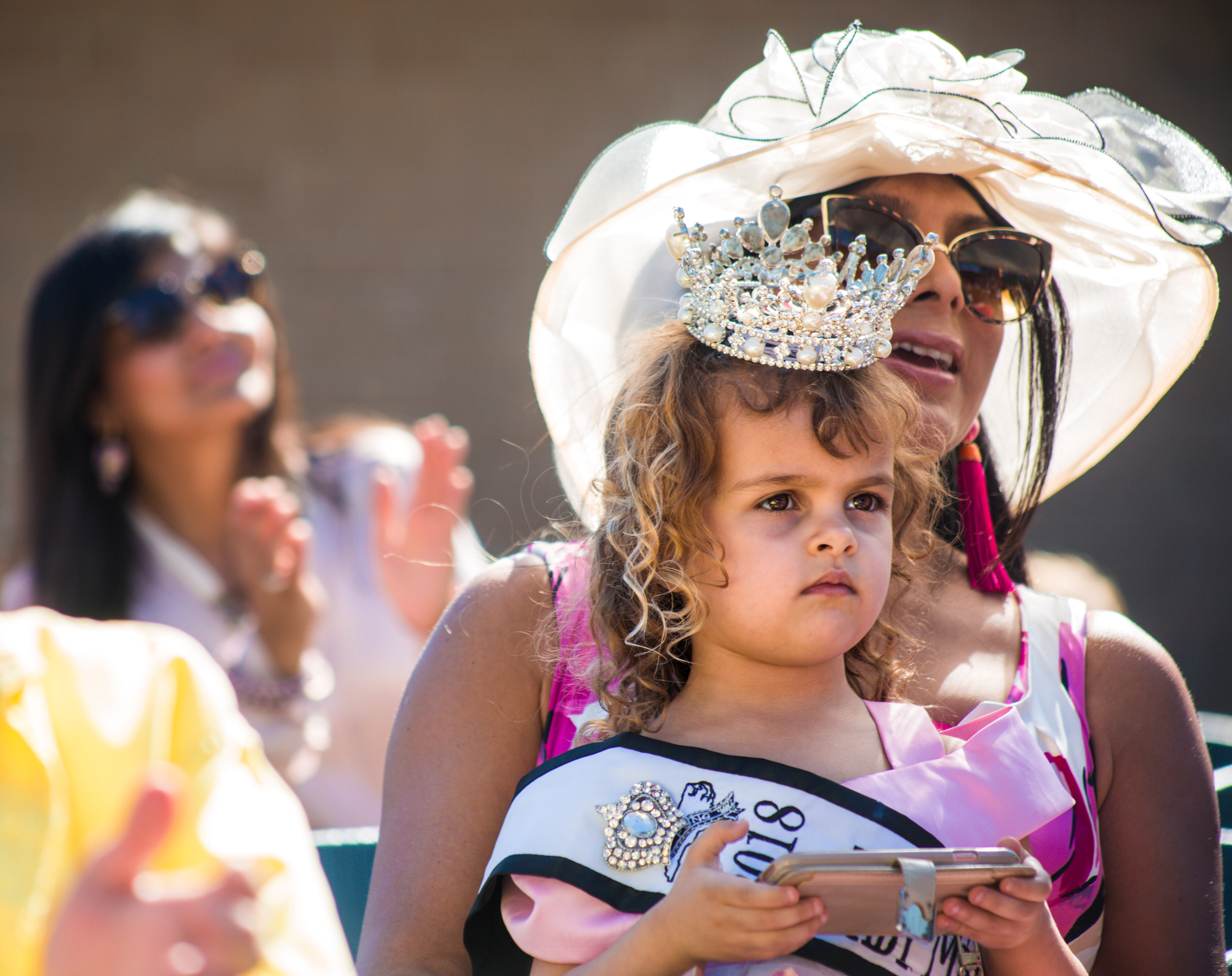 Baby Miss New Hanover, Kahlan Menendez, 3, and her mother, America, attends the Queen's Coronation at the 72nd North Carolina Azalea Festival at Greenfield Lake Amphitheatre in Wilmington, N.C., on Wednesday, April 3, 2019.